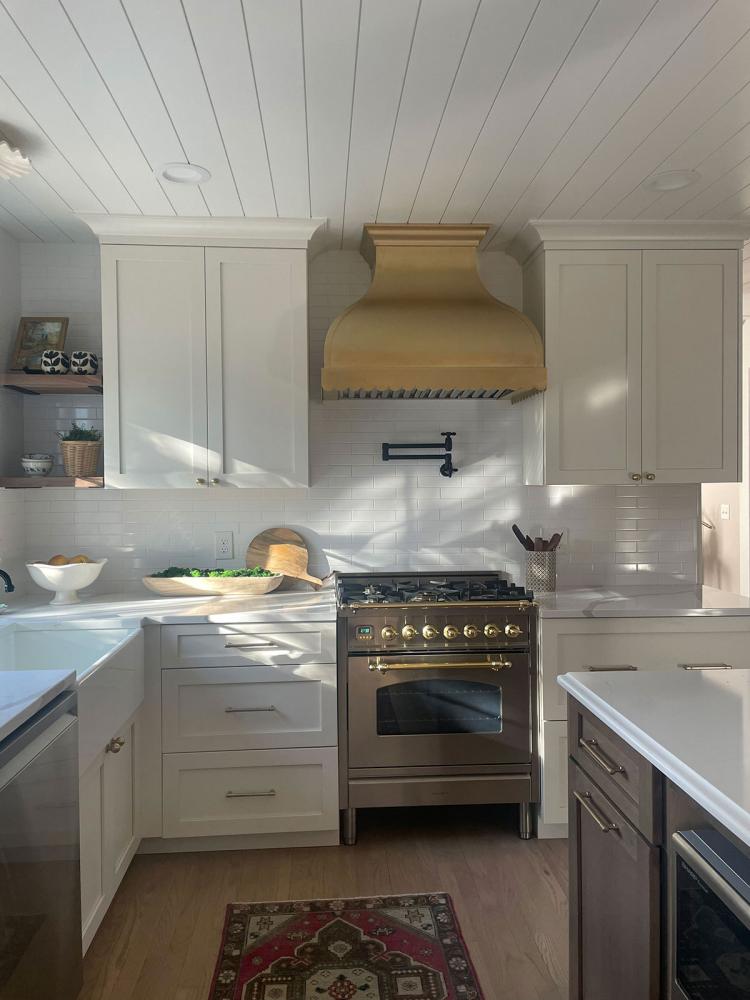 white kitchen with brass hood
