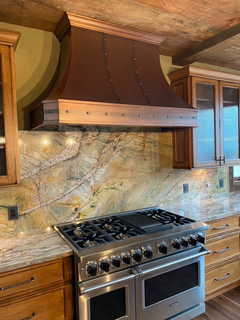 marbled backsplash and wood ceilings