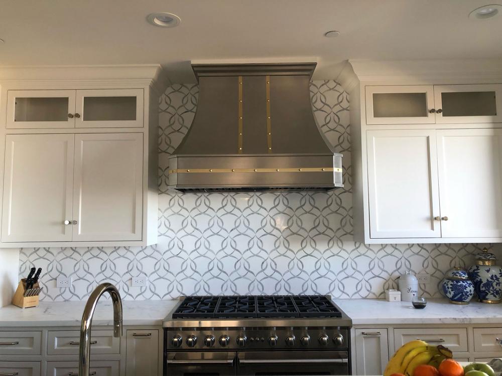 silver range hood and backsplash