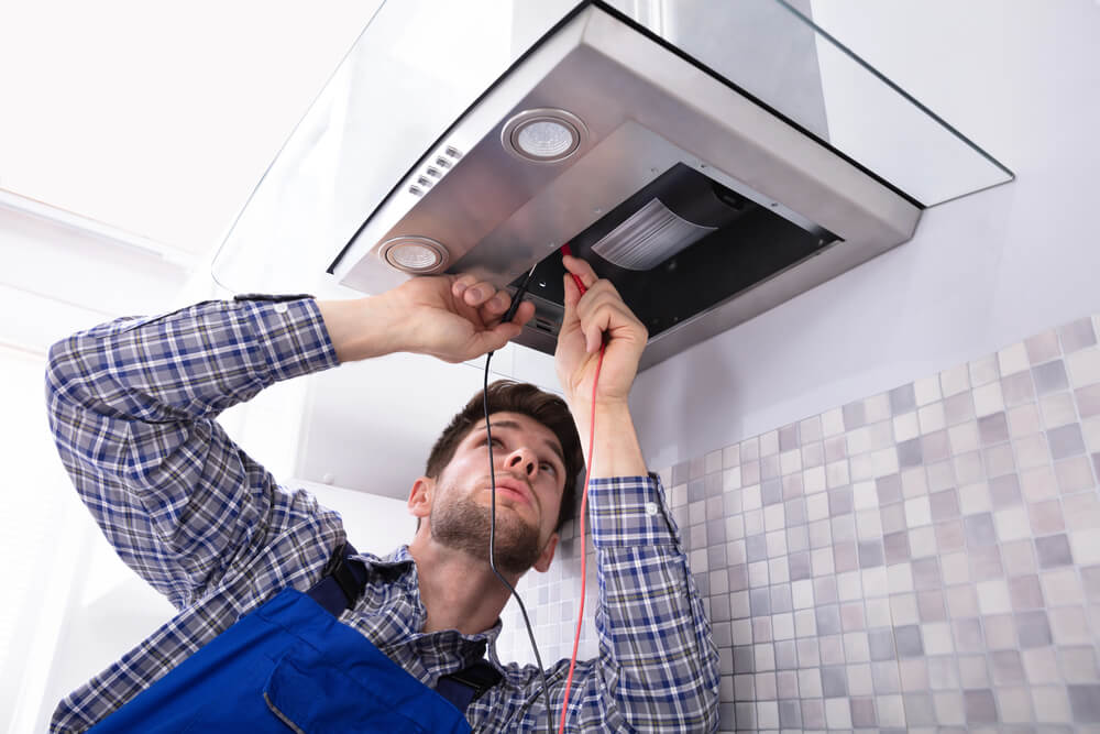 Do I need an electrician to replace my microwave with a range hood?