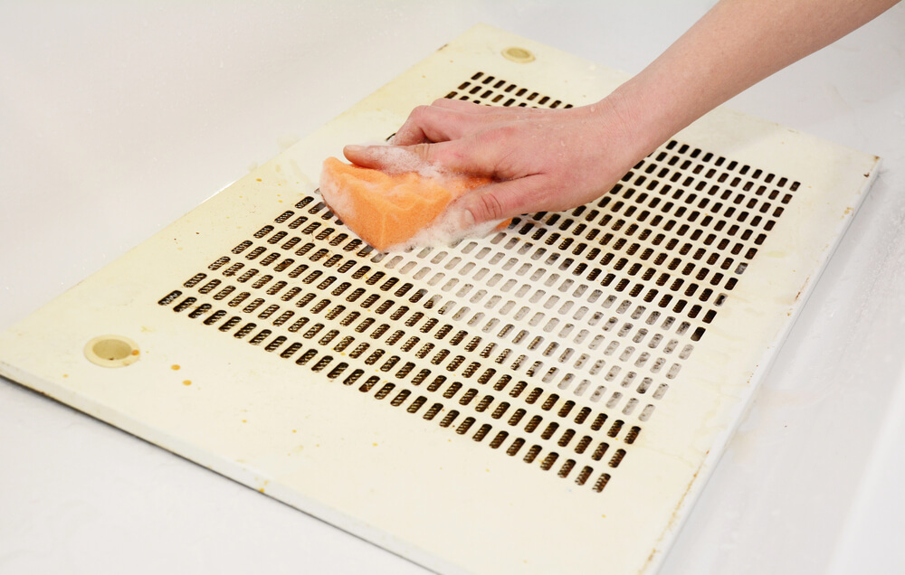 What are the benefits of cleaning vent hood filters?