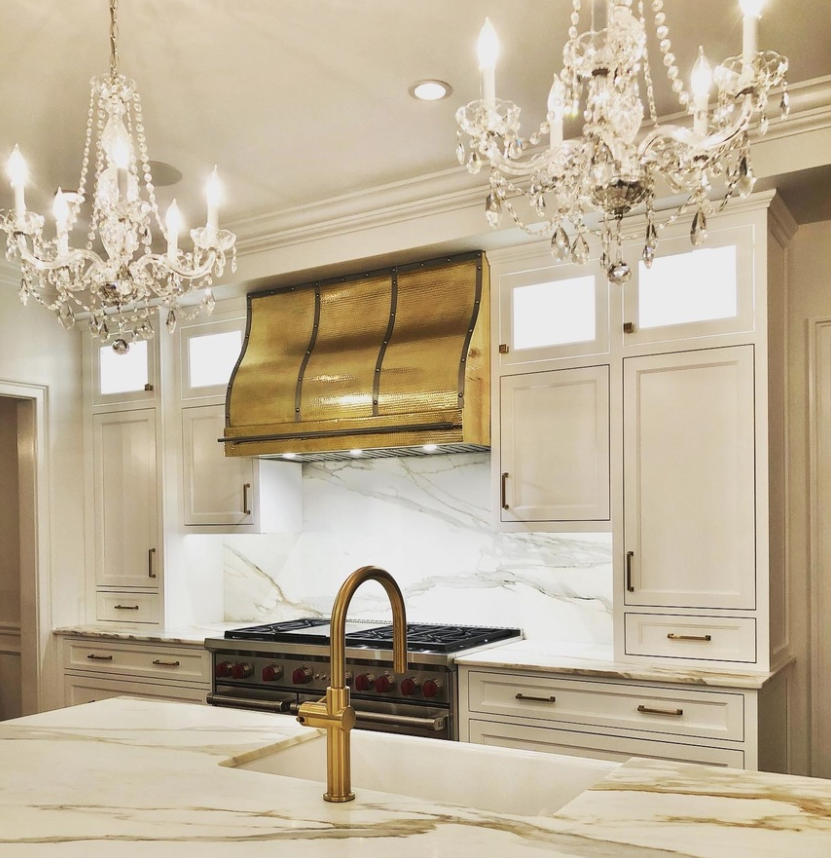 gold and brass range hood