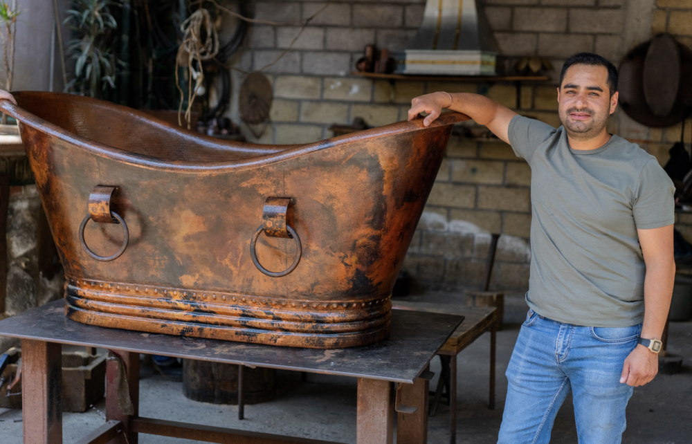 man with a custom copper bath tub