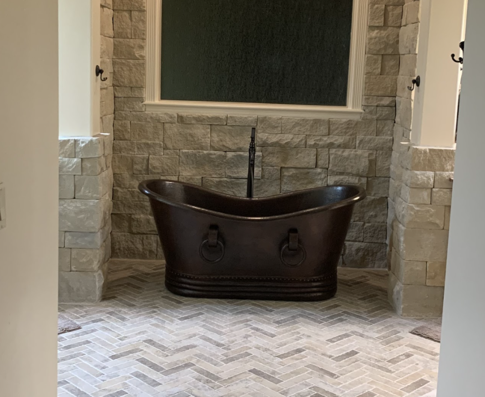custom bathtub with brick wall
