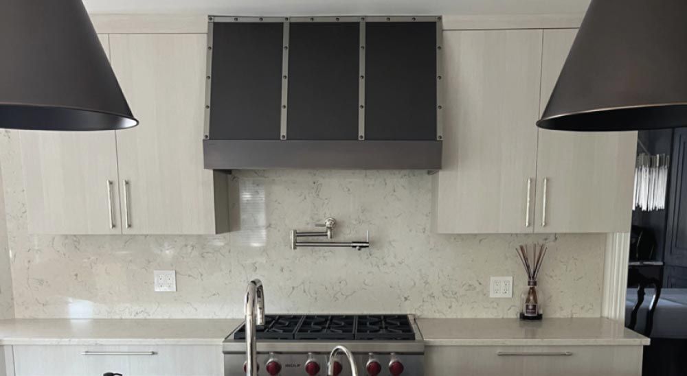 This Oakhurst Kitchen Nails Bold Contrast with a Custom Range Hood
