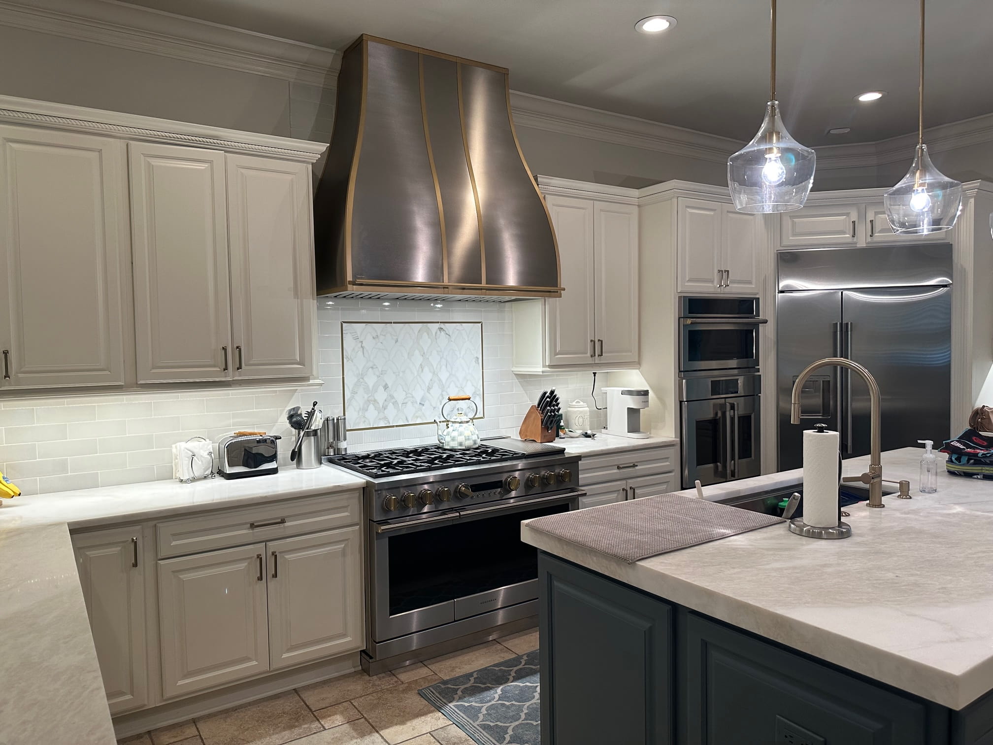 Artistry of french kitchen design, accentuated by pristine white kitchen cabinets and elegant white kitchen countertops, and mesmerizing marble backsplash