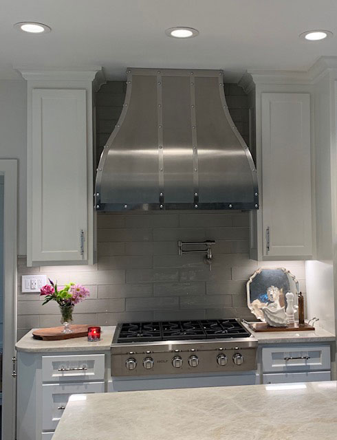 A range hood that complements the overall aesthetic, such as a sleek stainless steel hood for a modern look