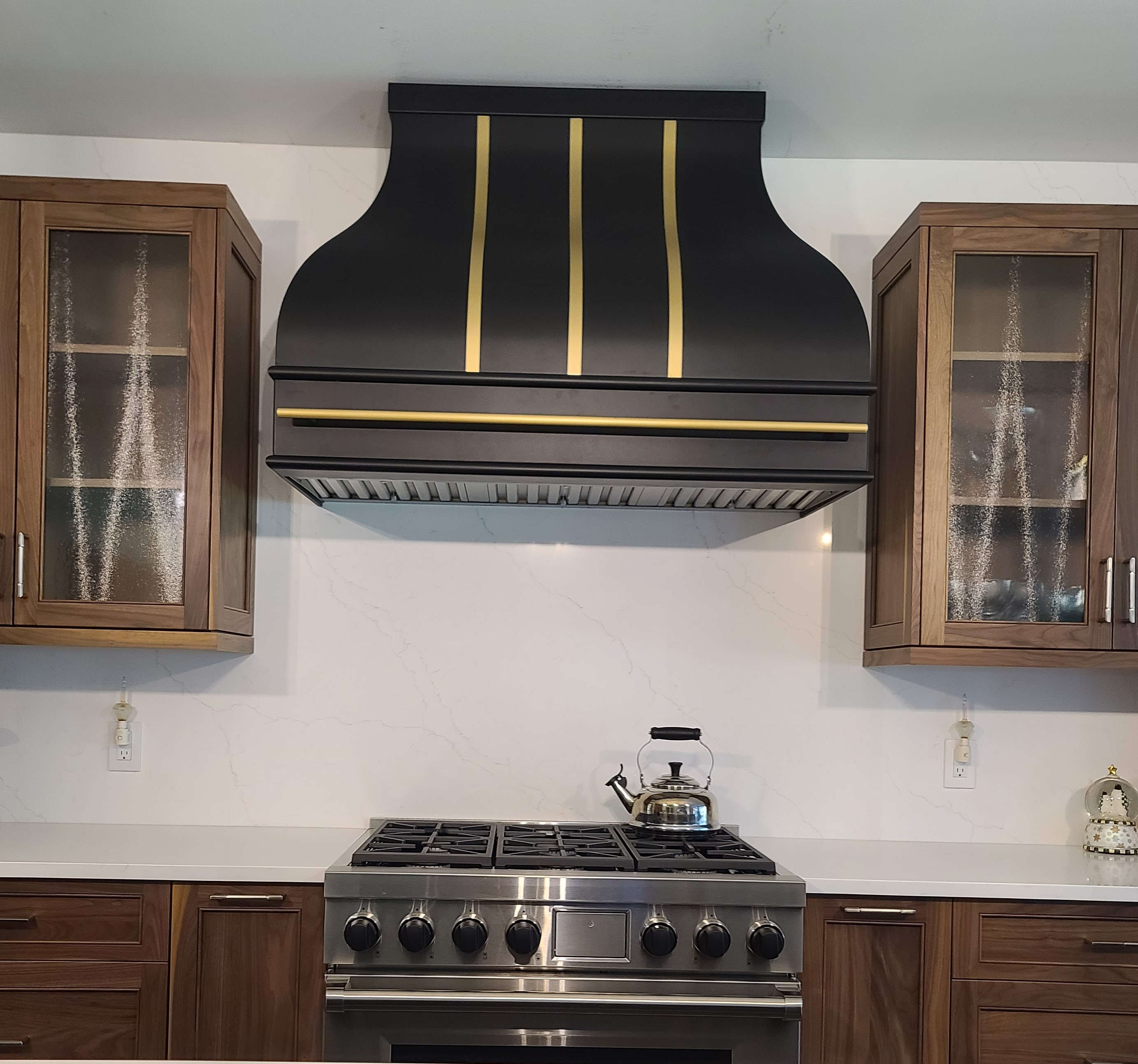 French kitchen design, showcasing brown kitchen cabinets, exquisite marble kitchen countertops, captivating marble backsplash, range hood