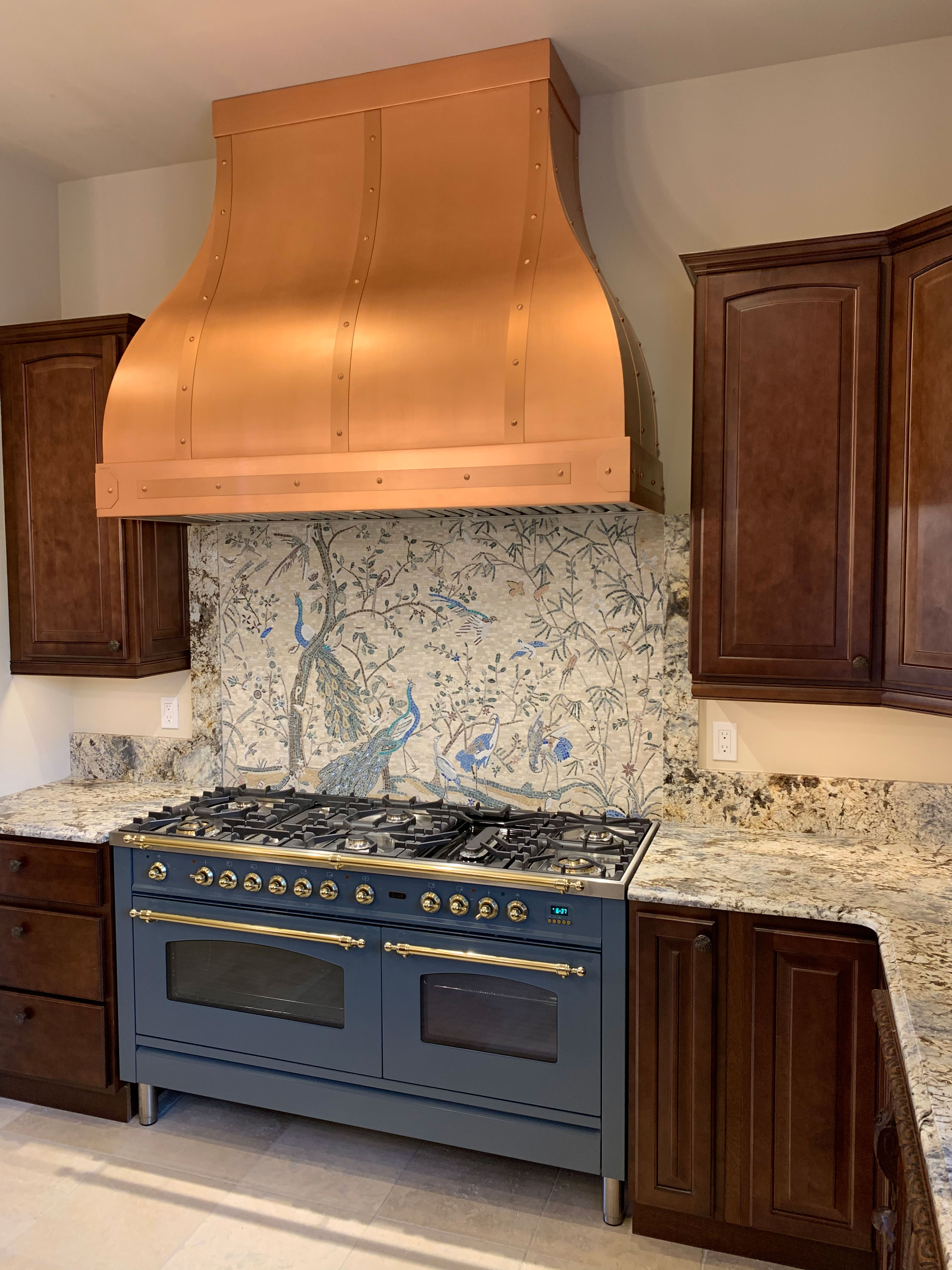 Large copper hood in kitchen with floral mural World CopperSmith