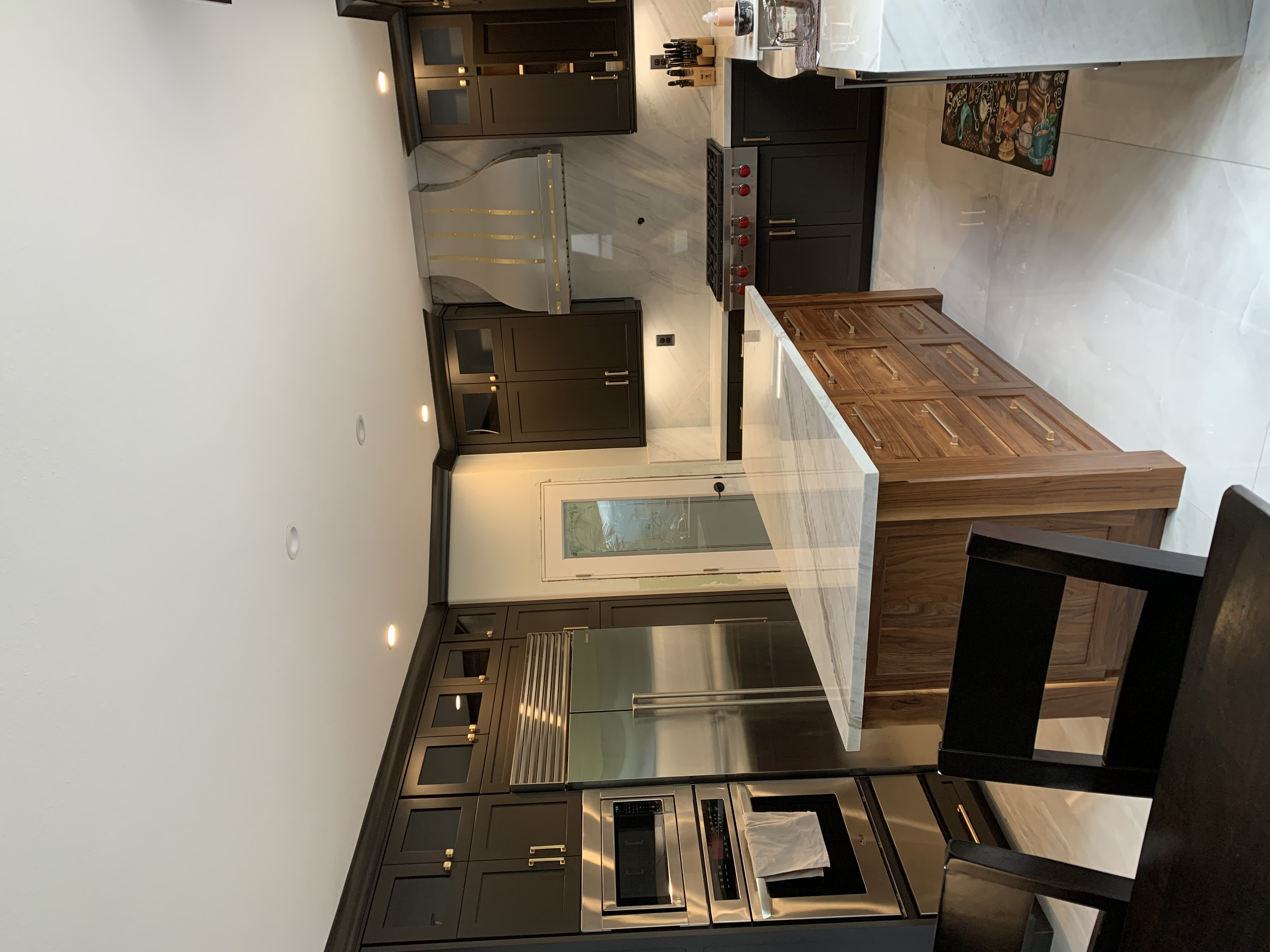 Creative kitchen design idea with various range hood options,french kitchen design,brown kitchen cabinets, pristine white kitchen countertops,marble backsplash