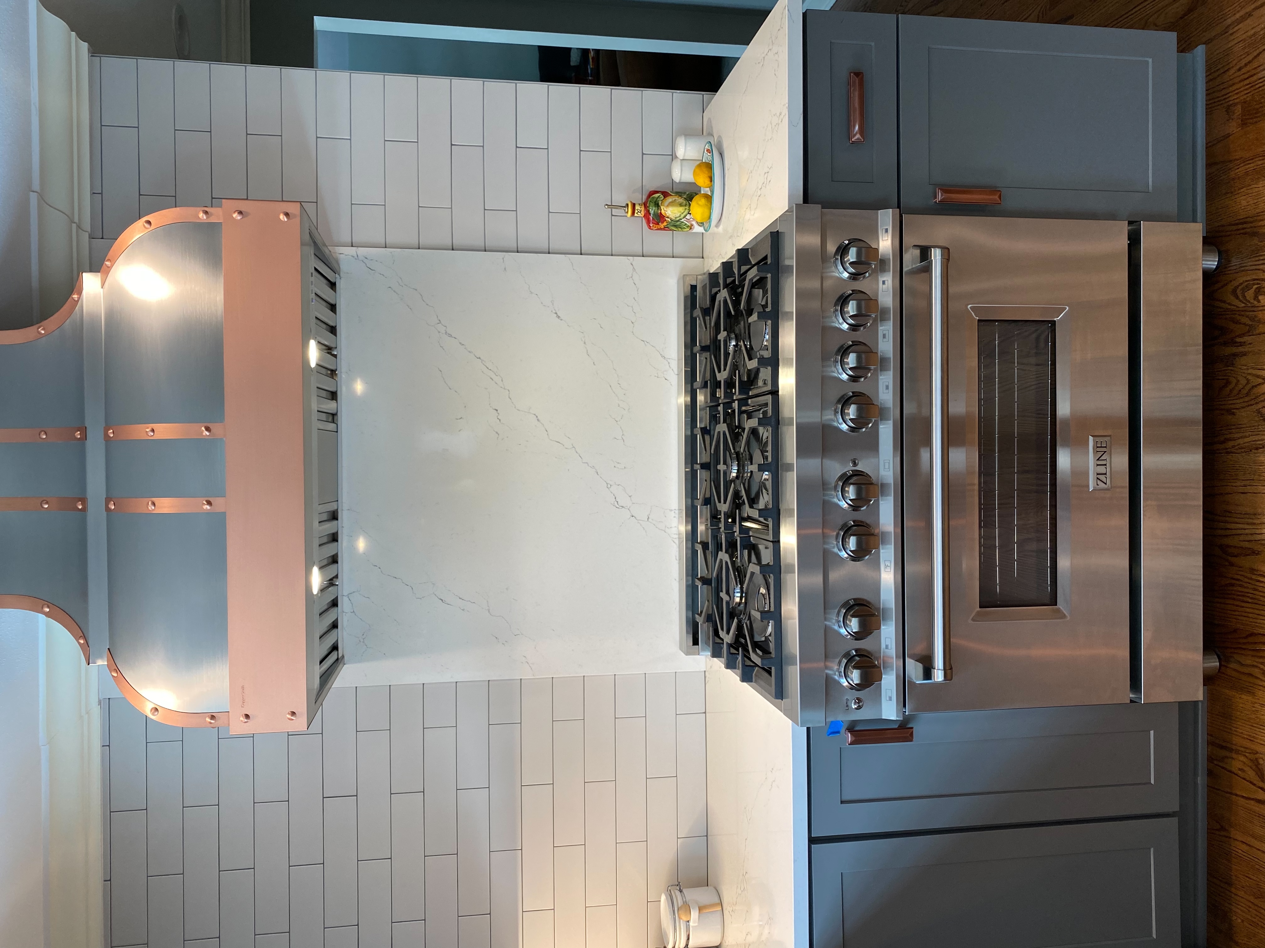 Kitchen design idea, including range hood options, elegant french kitchen designs,black kitchen cabinets, white kitchen countertops, and marble backsplash
