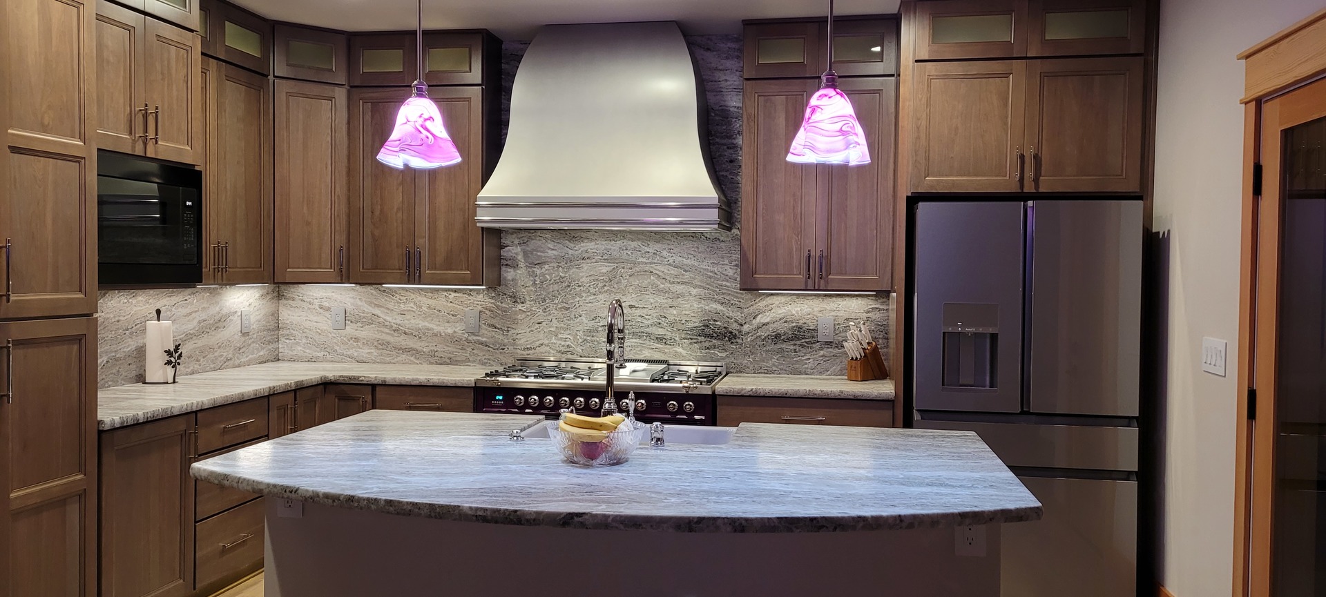 Charming kitchen design idea with kitchen sink, country kitchen designs, brown kitchen cabinets, marble kitchen countertops, and marble backsplash