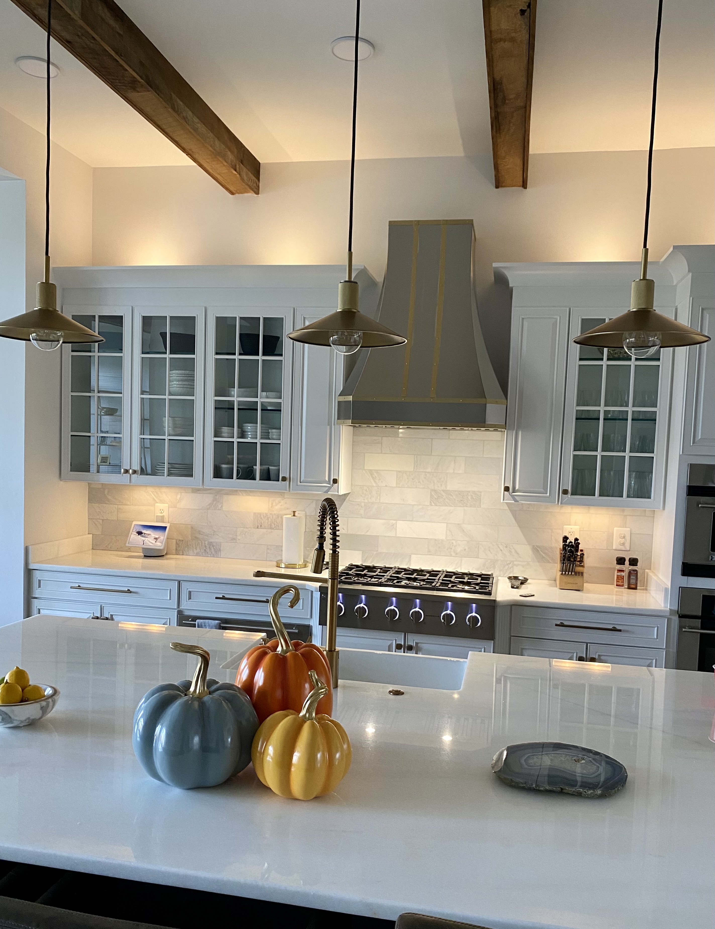 Timeless kitchen design idea with a classic kitchen, range hood styles, sleek white kitchen cabinets, marble kitchen countertops, and elegant marble backsplash