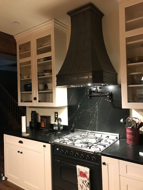 Kitchen design featuring,using range hood, white kitchen cabinets,grey kitchen countertops with marble backsplash