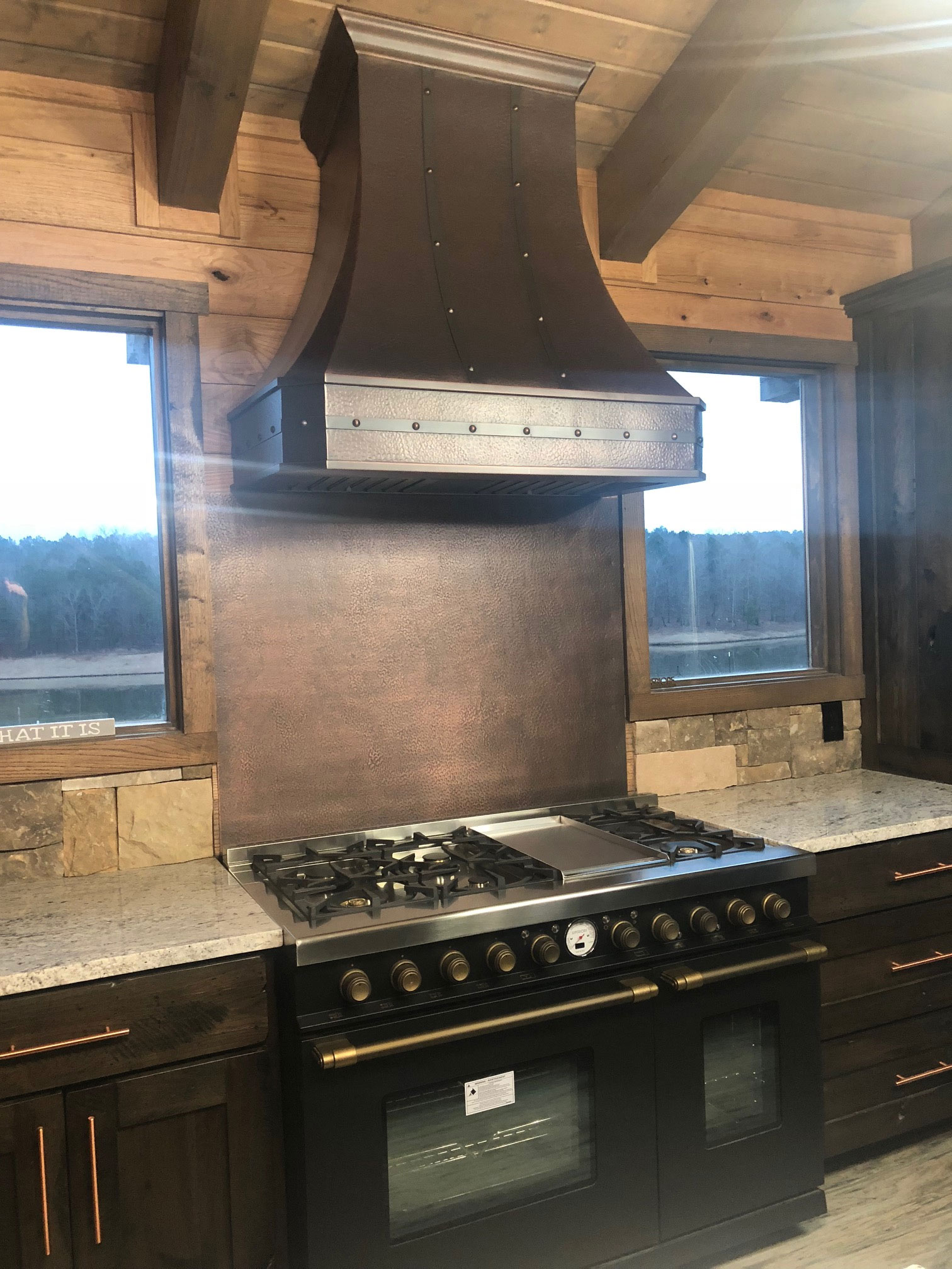 Range hood with copper backplate and gas stove World CopperSmith