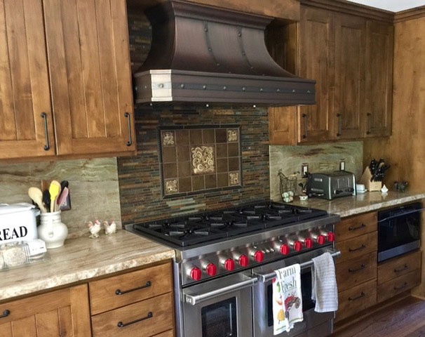 Kitchen design idea with range hood, brown kitchen cabinets marble kitchen countertops,marble backsplash