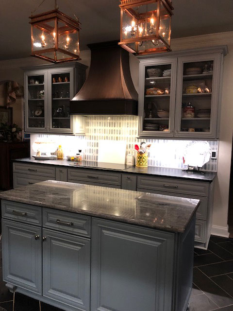 Inspiring kitchen design idea with incorporating range hood , white cabinets,marble countertops,captivating marble backsplash