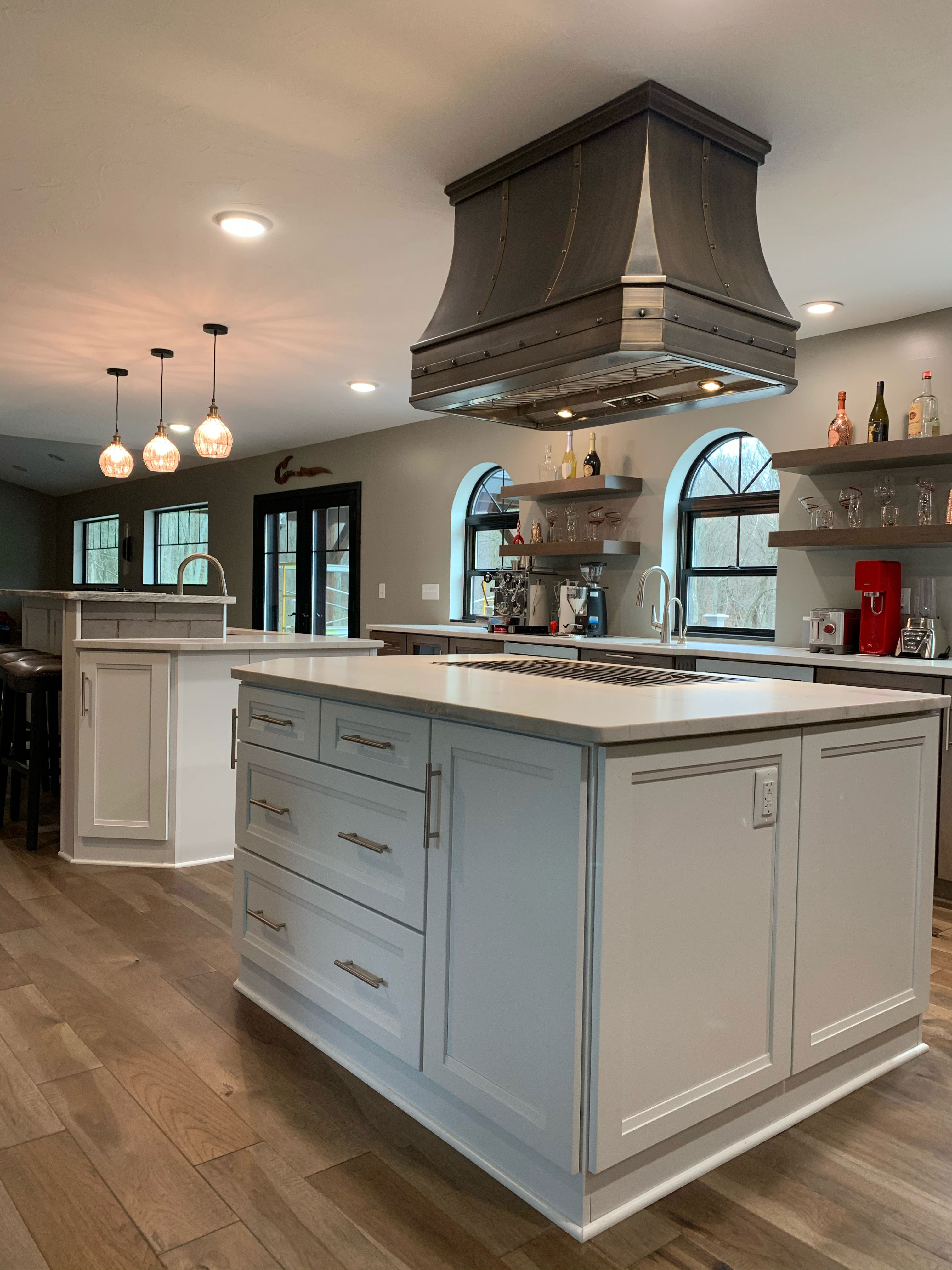 Embrace french kitchen design by white cabinets, marble countertops, captivating brick backsplash,ra with range hood
