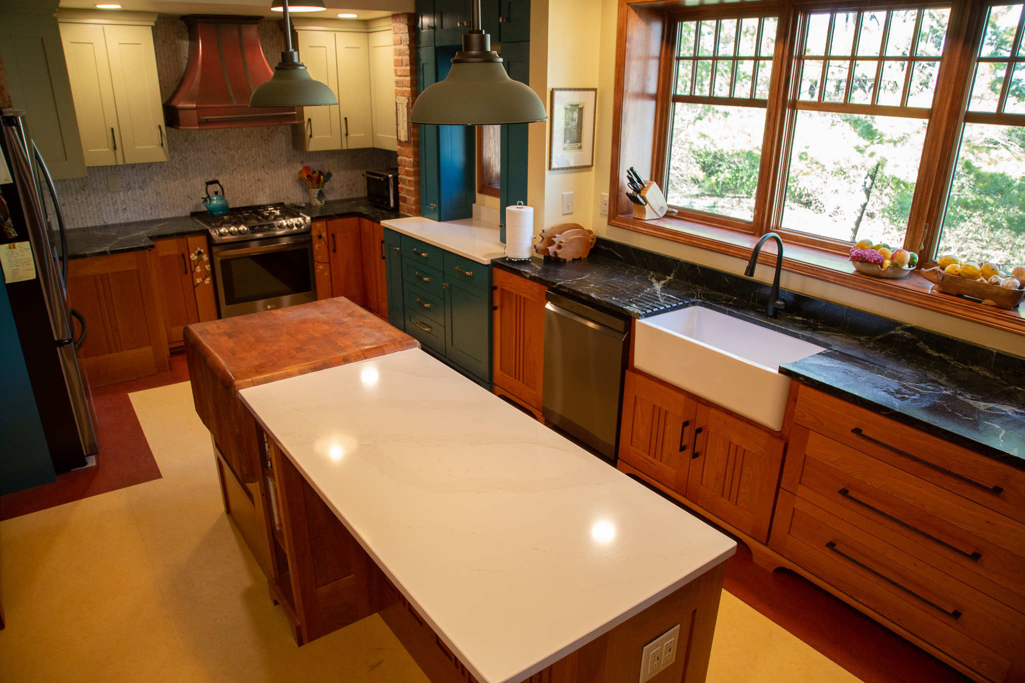 Copper range hood to complement rustic-inspired kitchen design, wood kitchen cabinets, elegant white kitchen countertops, timeless white tile backsplash