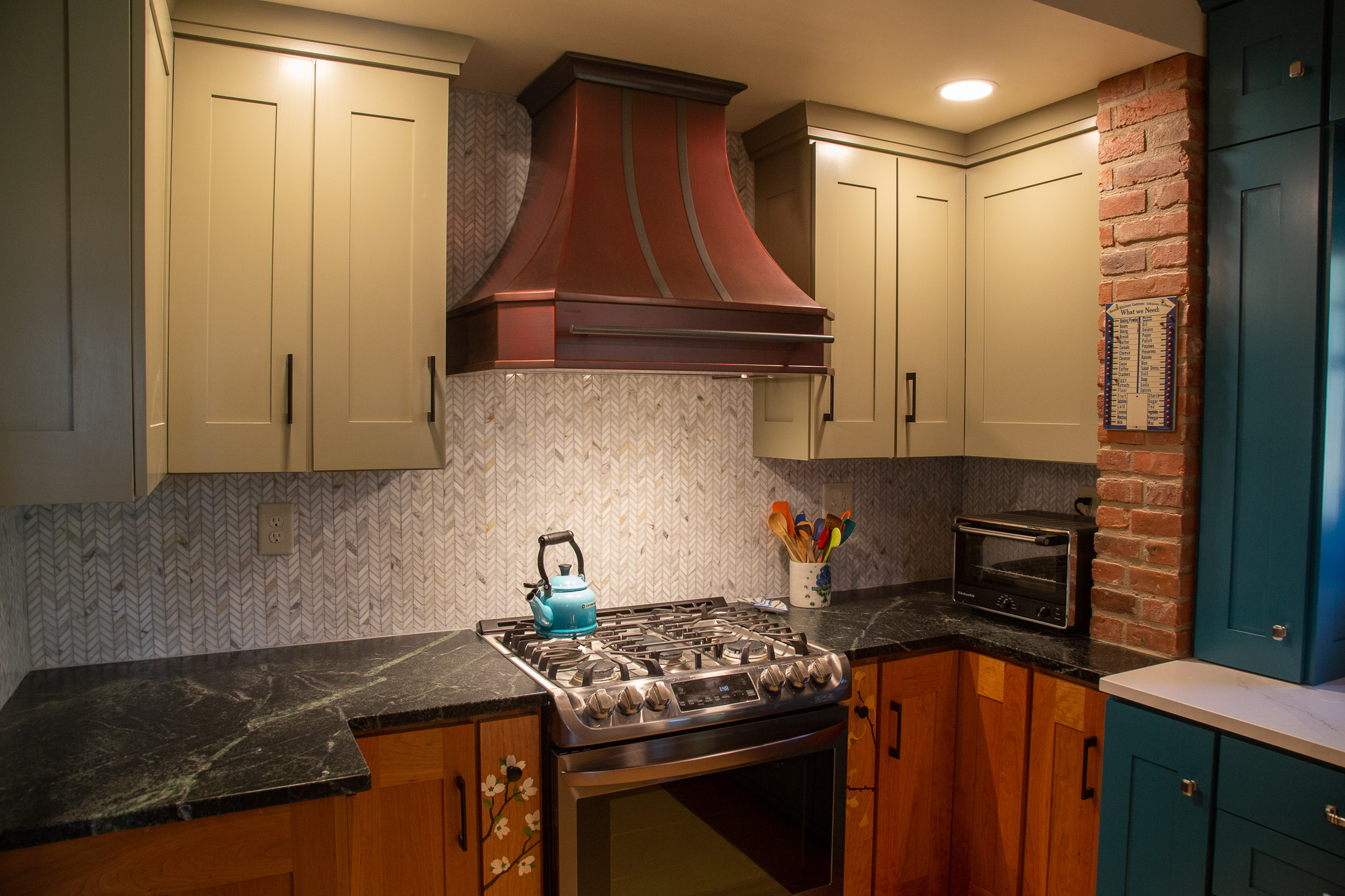 Stunning kitchen with rustic-inspired wood cabinets, sleek white countertops timeless white tile backsplash, all enhanced by a stylish range hood design