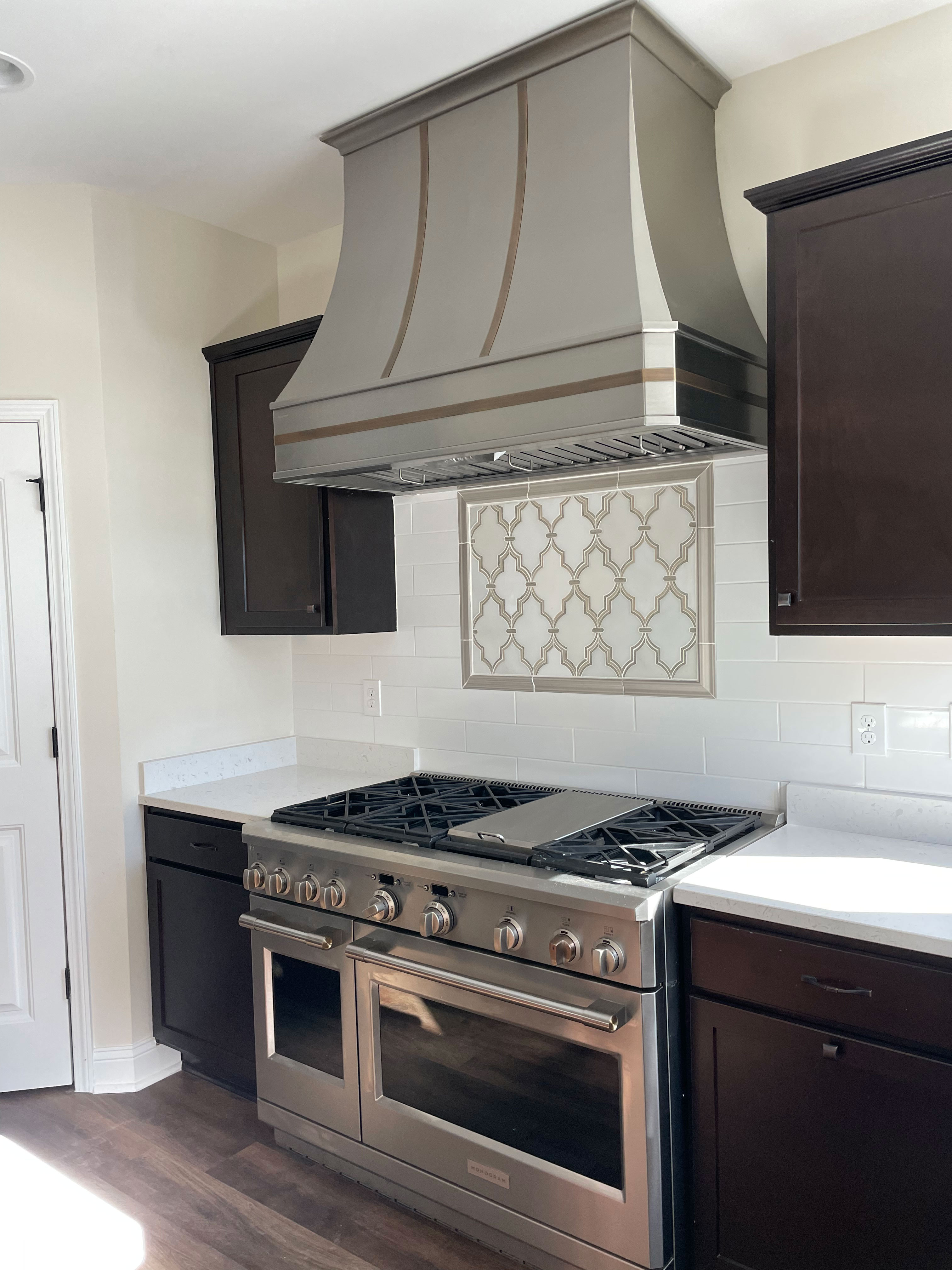Stunning french kitchen design innovative range hood featuring brown kitchen cabinets marble backsplash