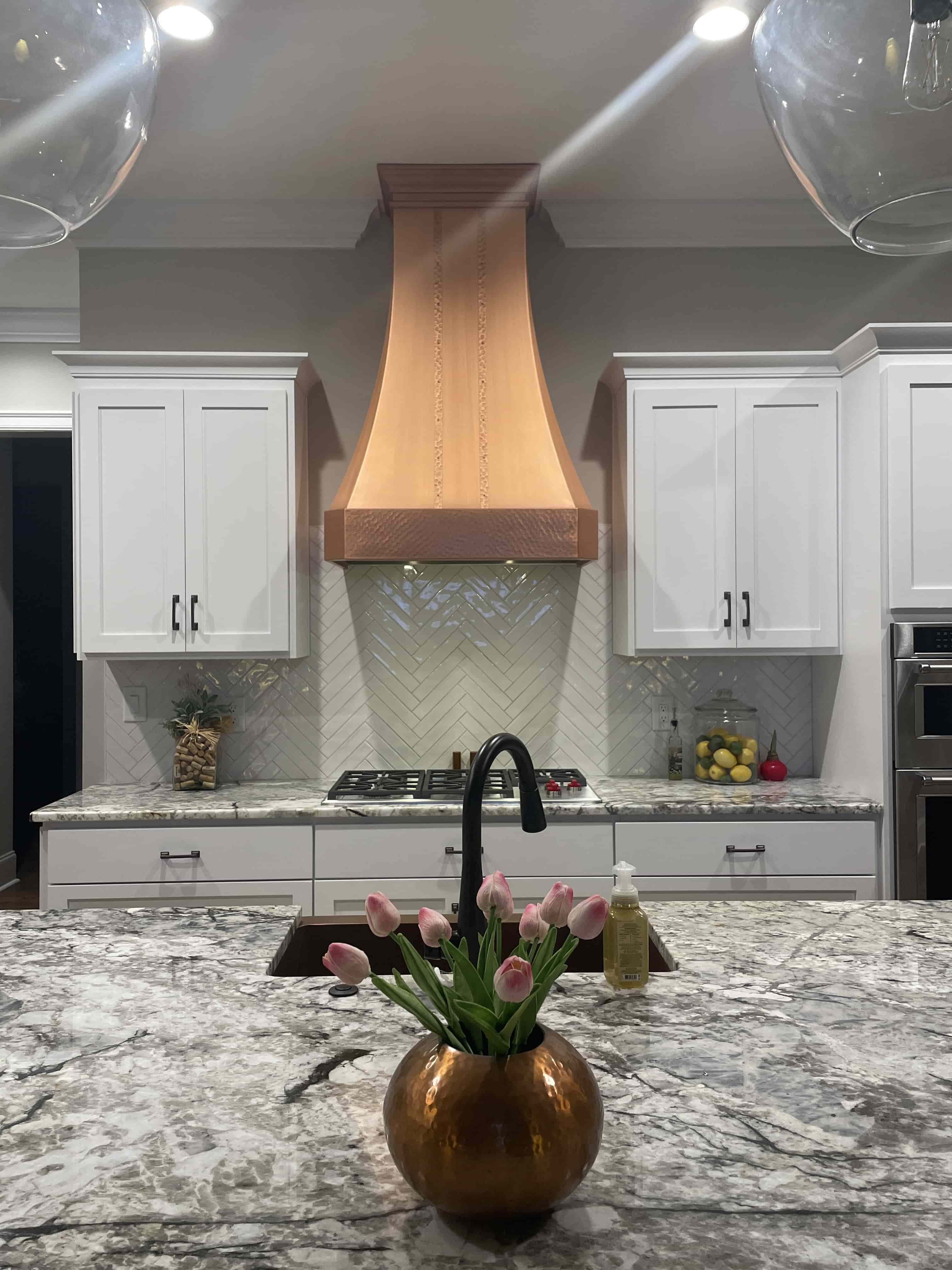 CopperSmith Classic CX5 Wall Mount Old Coin Copper Smooth with Straps and Rivets in a contemporary kitchen with marble countertops white cabinets and white tile backsplash