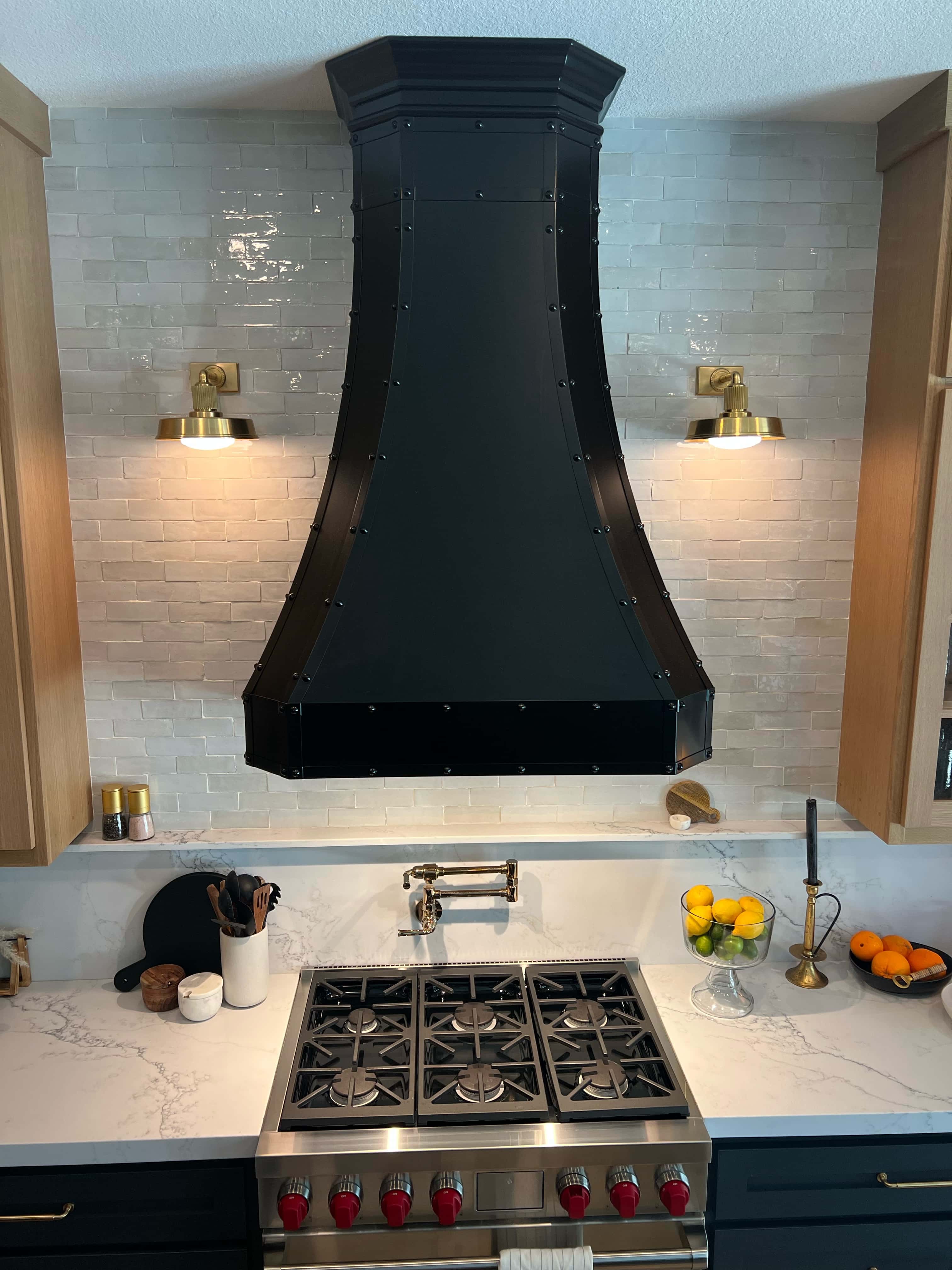 Marveles range hood marvels meet a tuscan-inspired gallery, black kitchen cabinets, andluxurious marble kitchen countertops