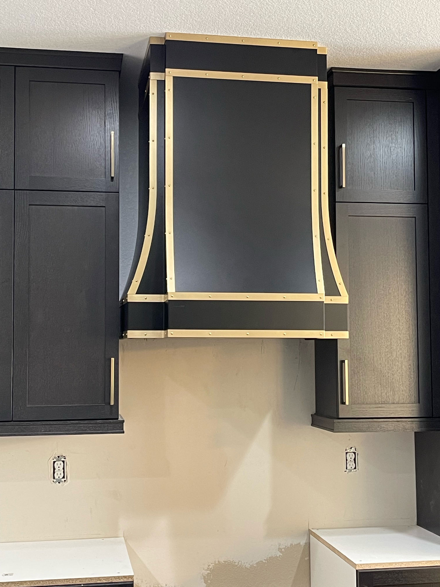 Black range hood with seven sides and copper lines World CopperSmith