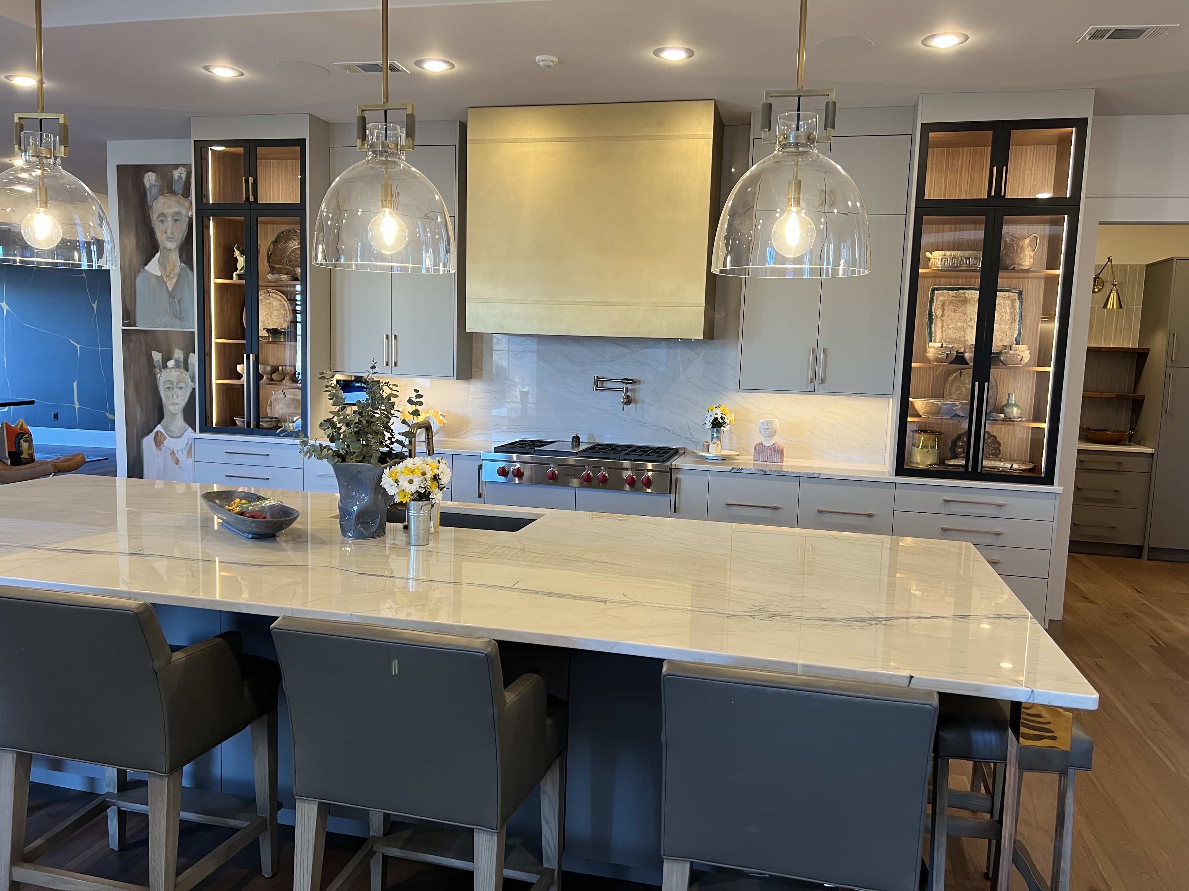 Charming range hood options, a timeless white kitchen cabinets paired with luxurious marble countertops, stunning white tile backsplash,