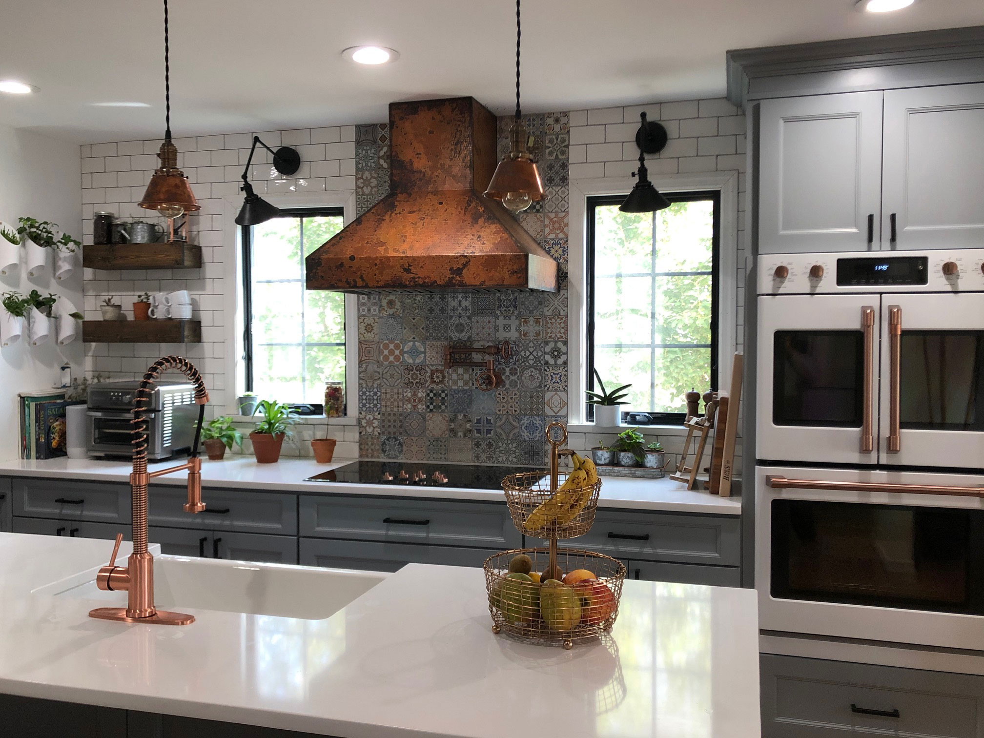 Copper range hood with muted finish in a kitchen with other copper elements. World CopperSmith