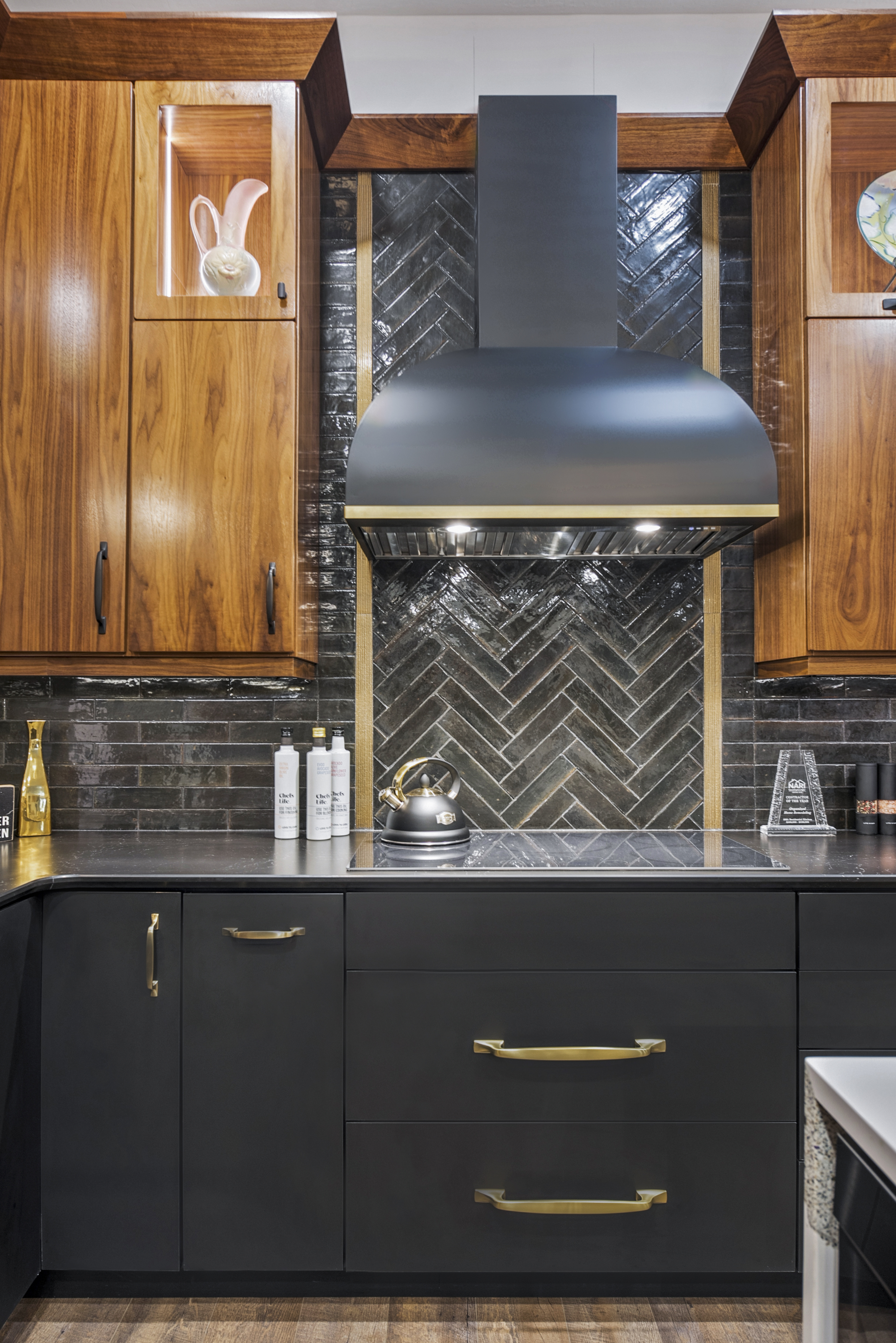 A classic kitchen planning with grey kitchen cabinets and quartz kitchen countertops enhanced by incorporating a stylish range hood