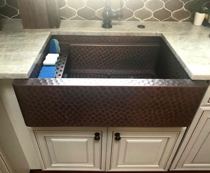 Copper apron sink with a recessed style in a white kitchen World CopperSmith