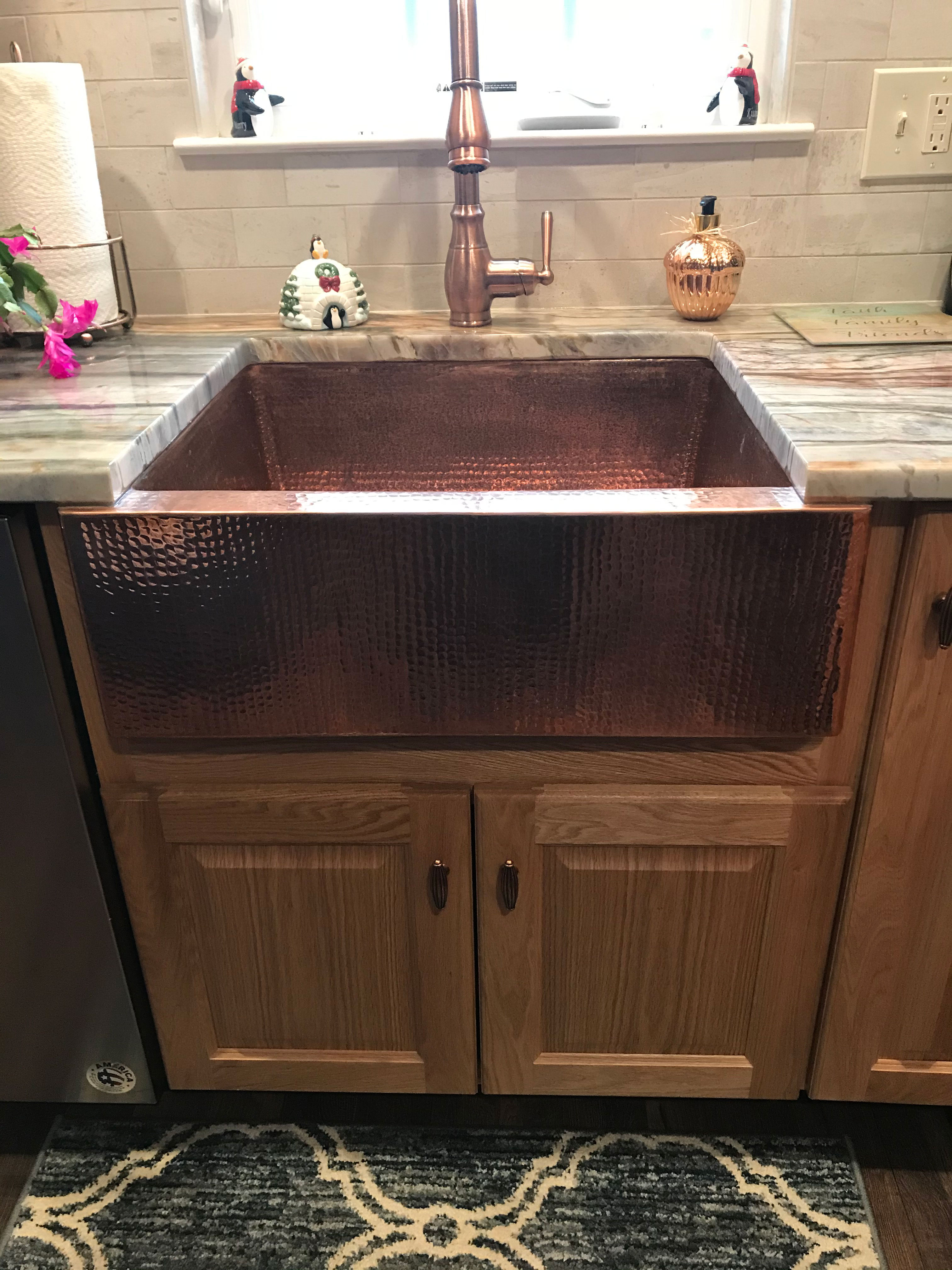 Kitchen design idea sink design idea features wood kitchen cabinets, white kitchen countertops and brick backsplash