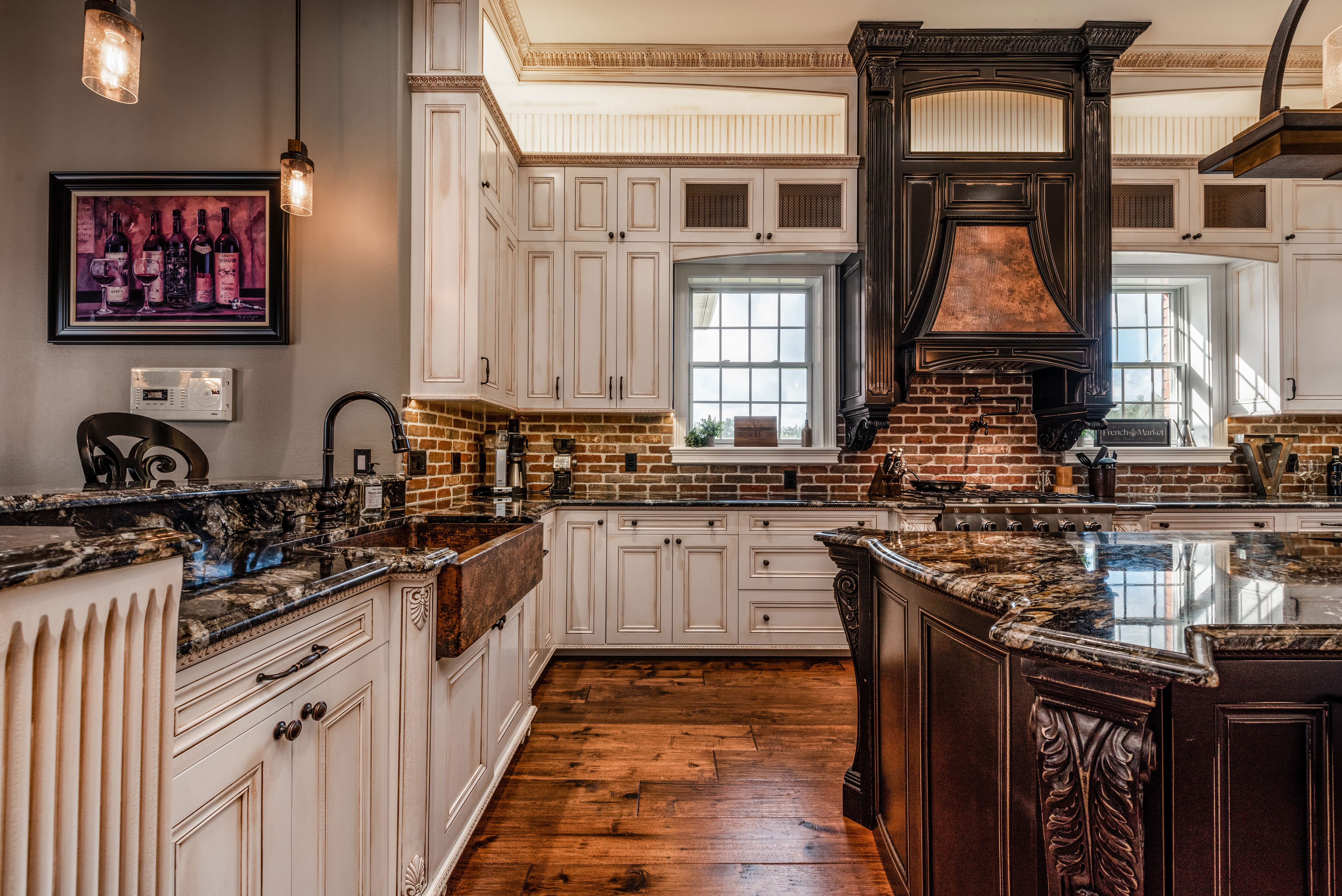 Country kitchen design features grey kitchen cabinets, marble kitchen countertops and brick backsplash