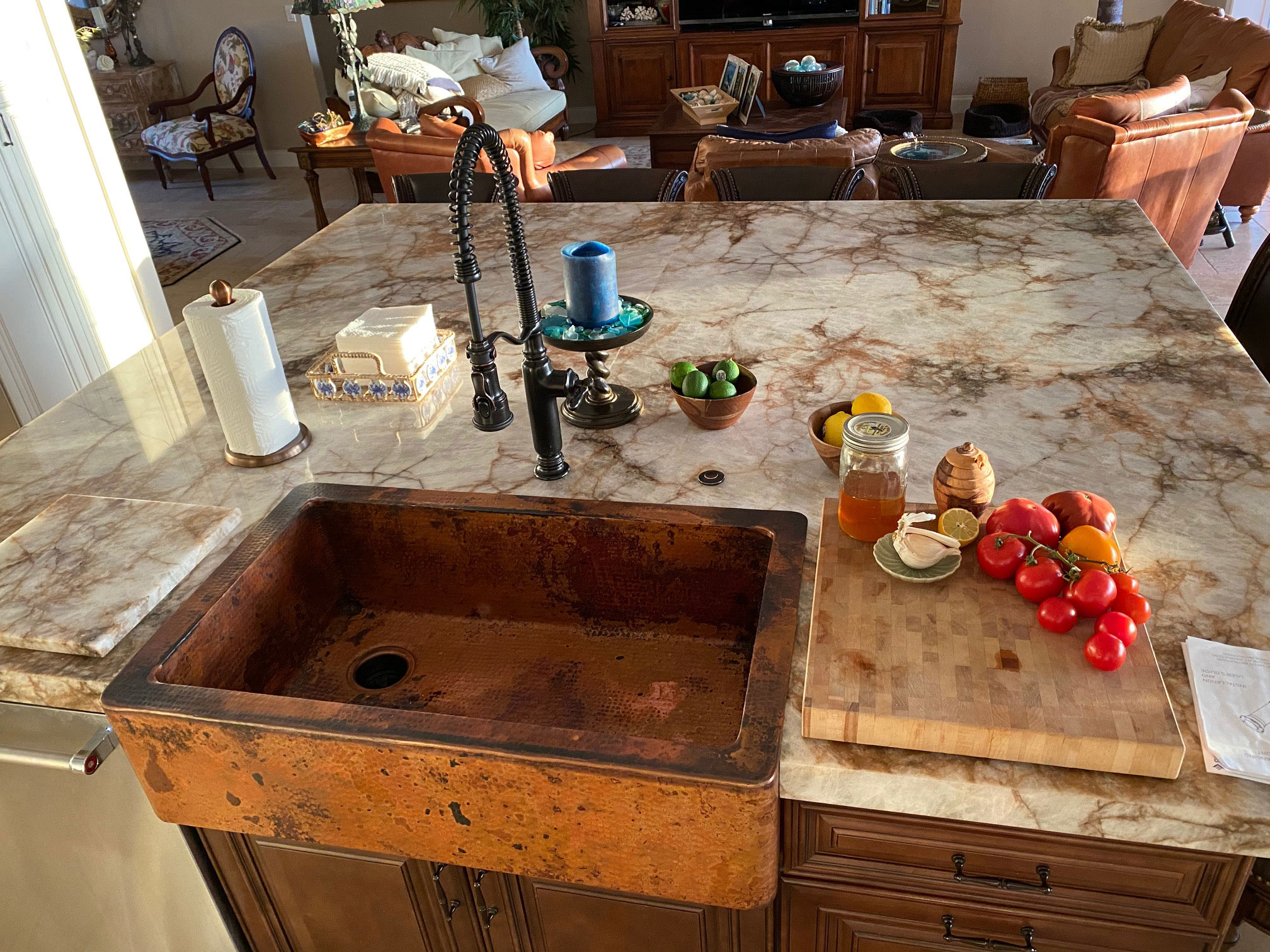 Copper apron sink with a recessed build on a kitchen island