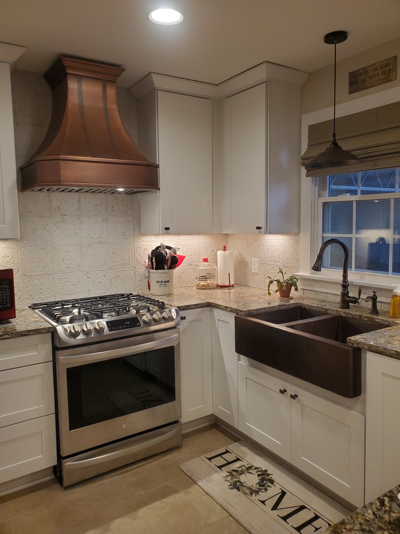 Kitchen design with range hood, white cabinets and marble countertops mesmerizing marble backsplash