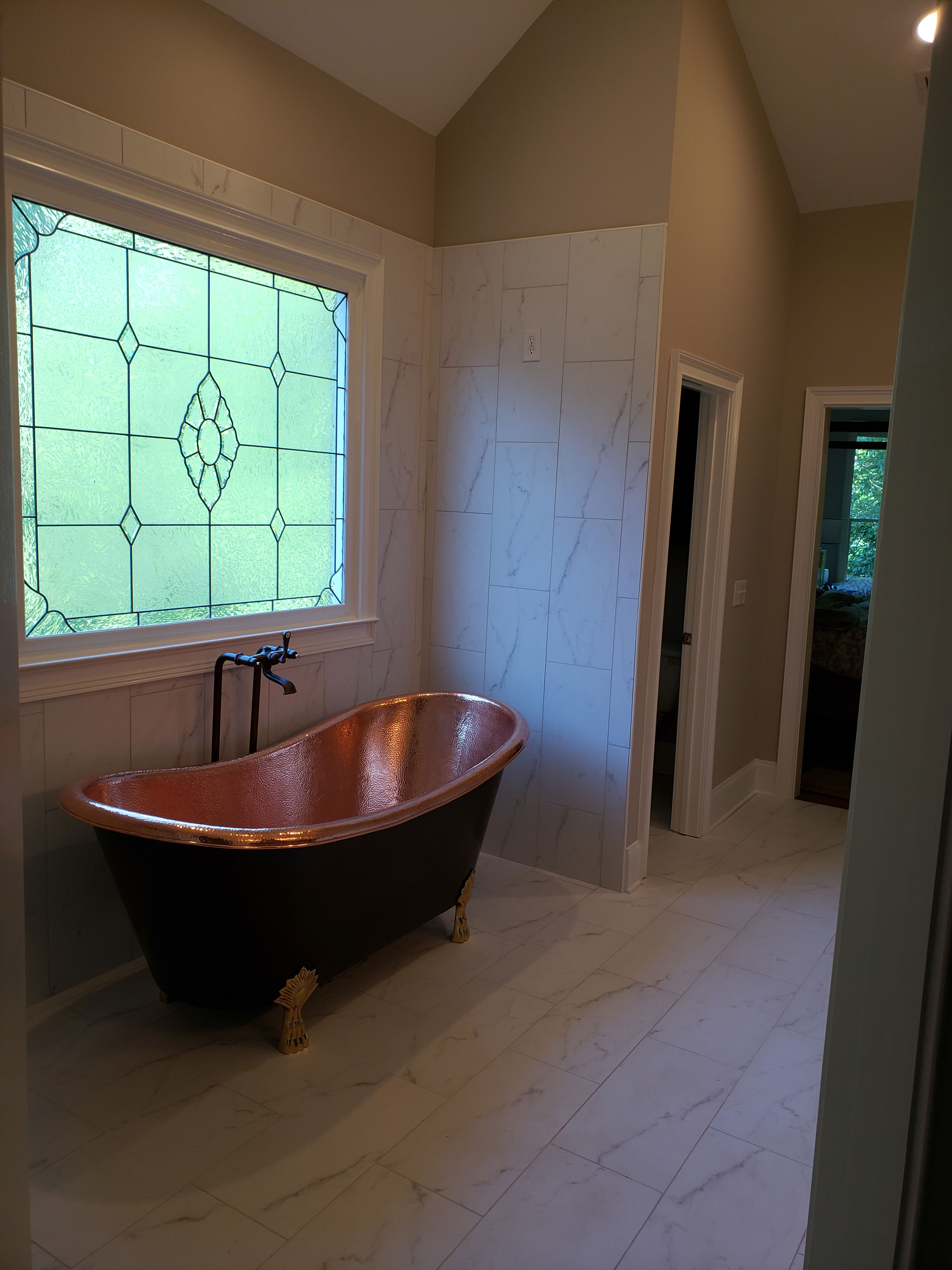 Luxurious bathroom design idea with a stylish bathtub and elegant marble backsplash