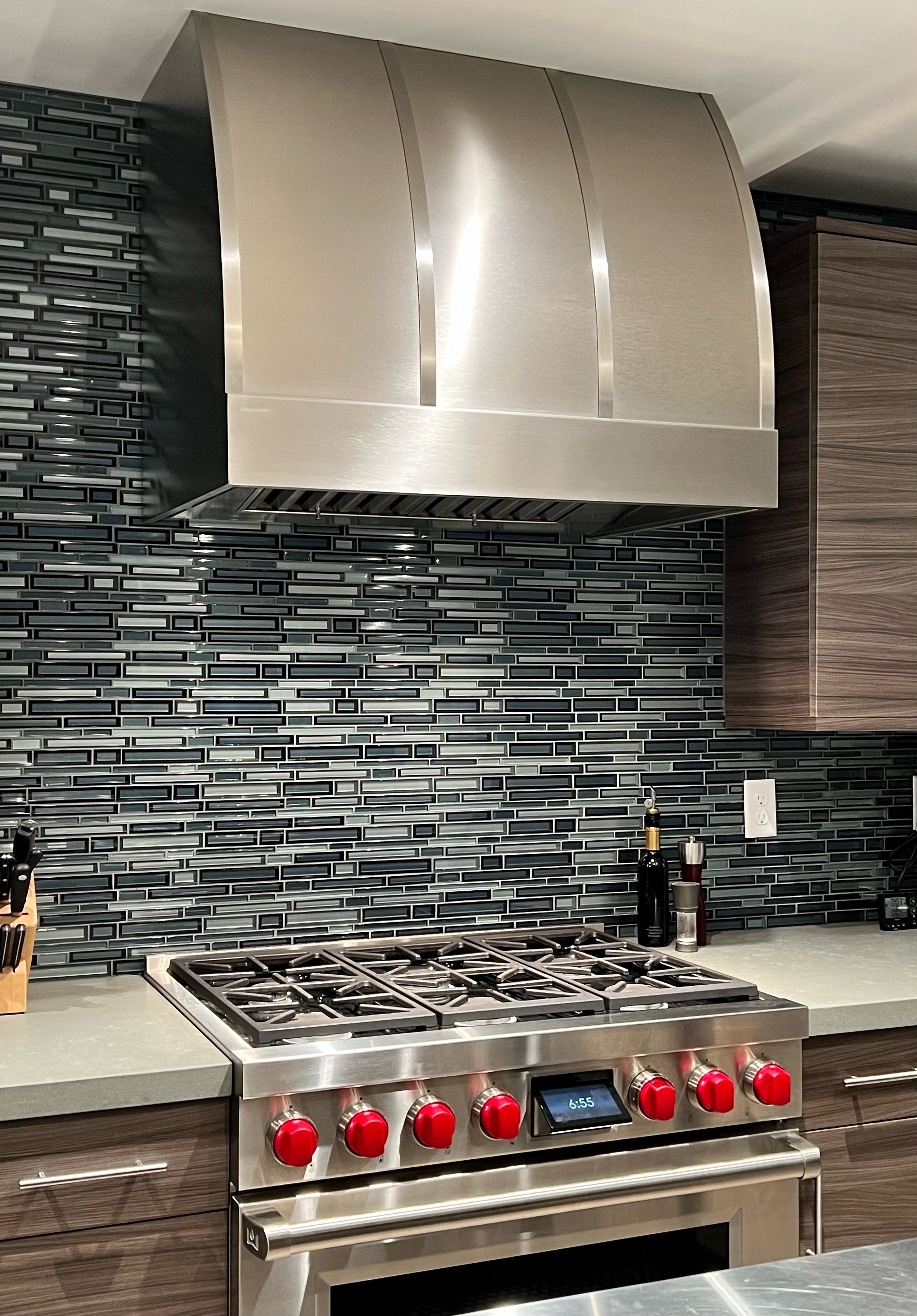 Stylish range hood options kitchen design idea incorporating classic kitchen planning, white kitchen cabinets, marble kitchen countertops, and marble backsplash