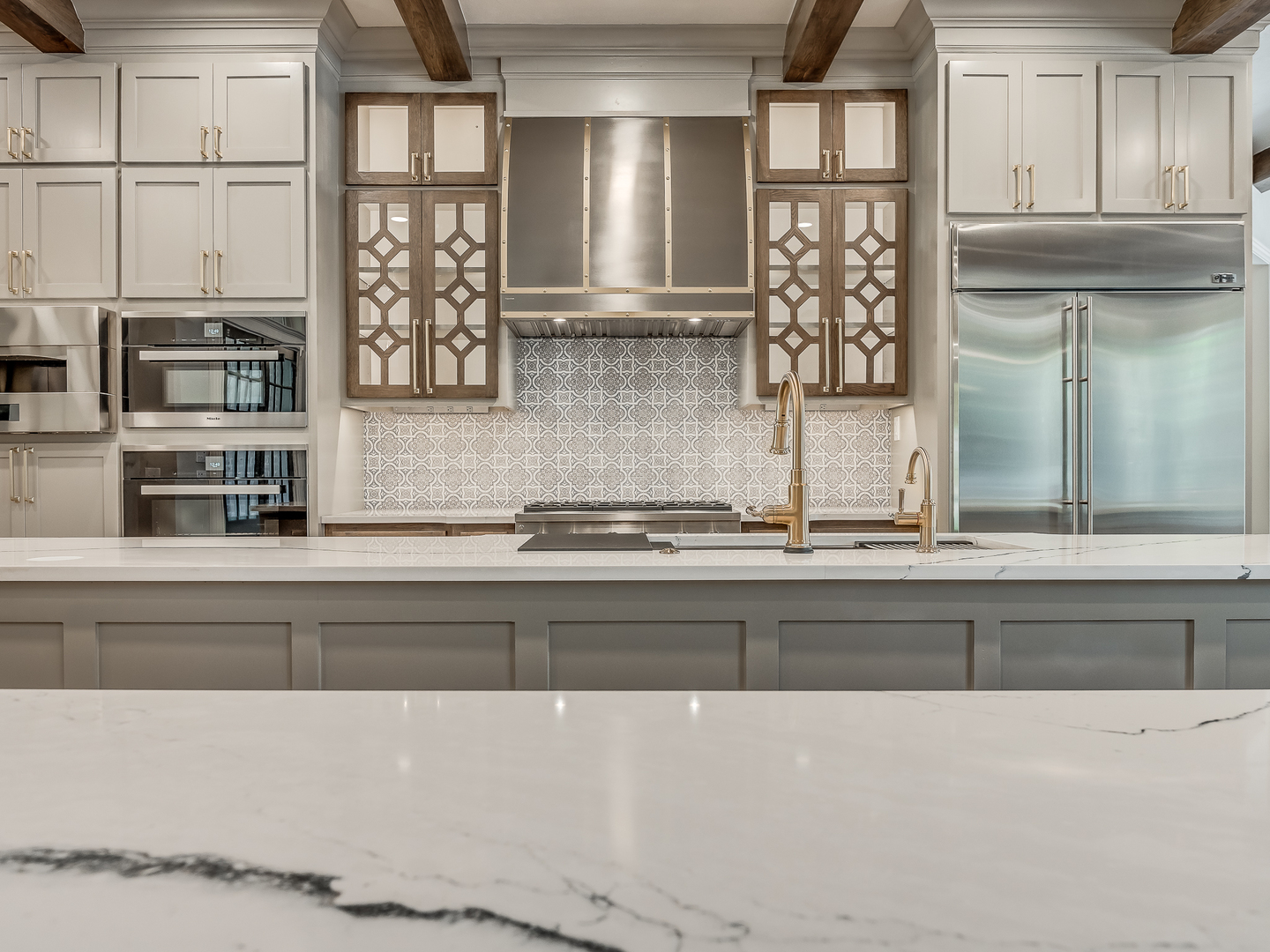 Innovative kitchen design idea,range hood options, contemporary kitchen styles, crisp white kitchen cabinets, white kitchen countertops, and marble backsplash