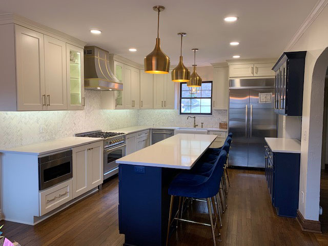 Beautiful coastal kitchen with white kitchen cabinets and countertops, complemented by a brick backsplash