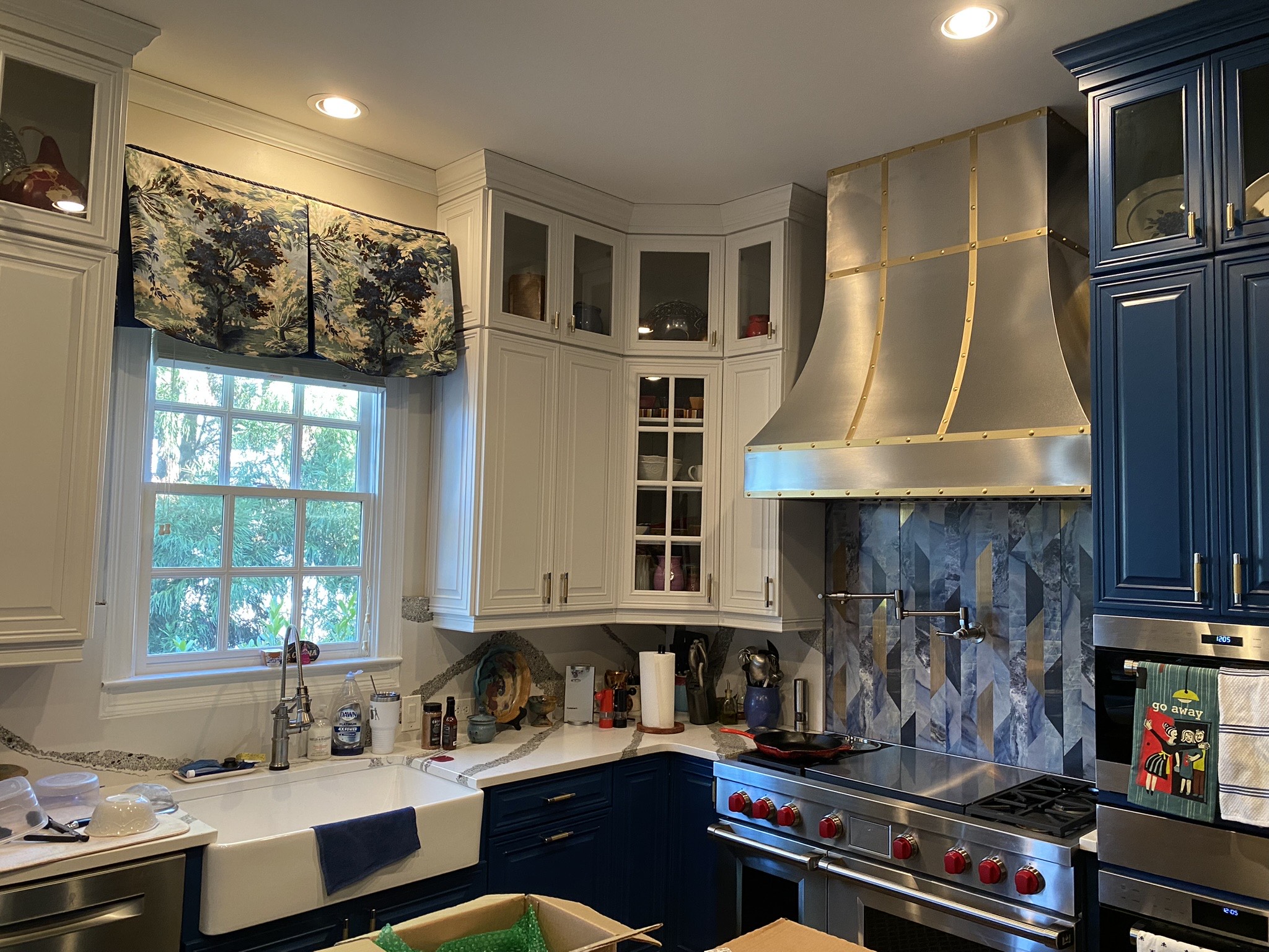 Remarkable kitchen design idea featuring blue kitchen cabinets, marble kitchen countertops, a marble backsplash