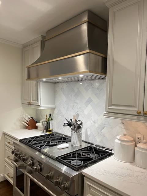 Small kitchen with stainless steel range hood and white cabinets World CopperSmith
