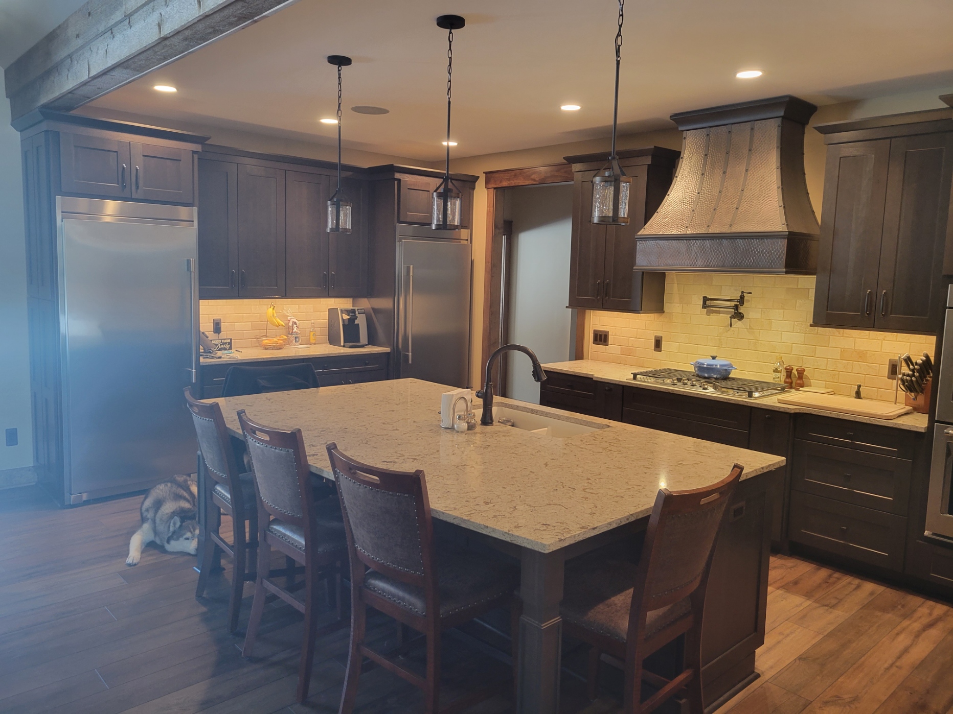 Modern kitchen design idea, sleek range hood options,kitchen techniques, brown kitchen cabinets,marble kitchen countertops, and brick backsplash