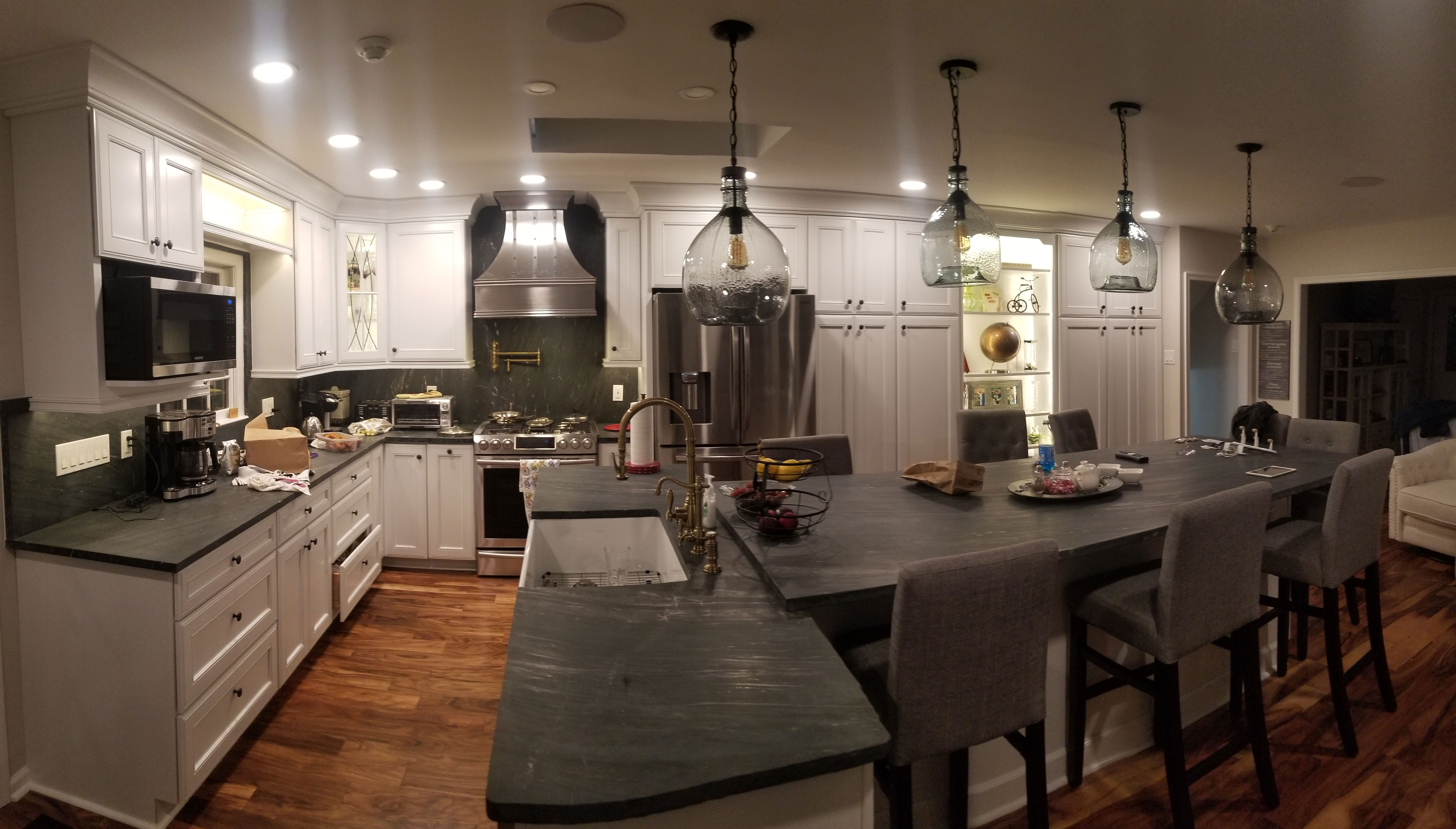 Exquisite kitchen with traditional design, range hood, showcasing elegant white kitchen cabinets, sleek grey kitchen countertops, stunning marble backsplash