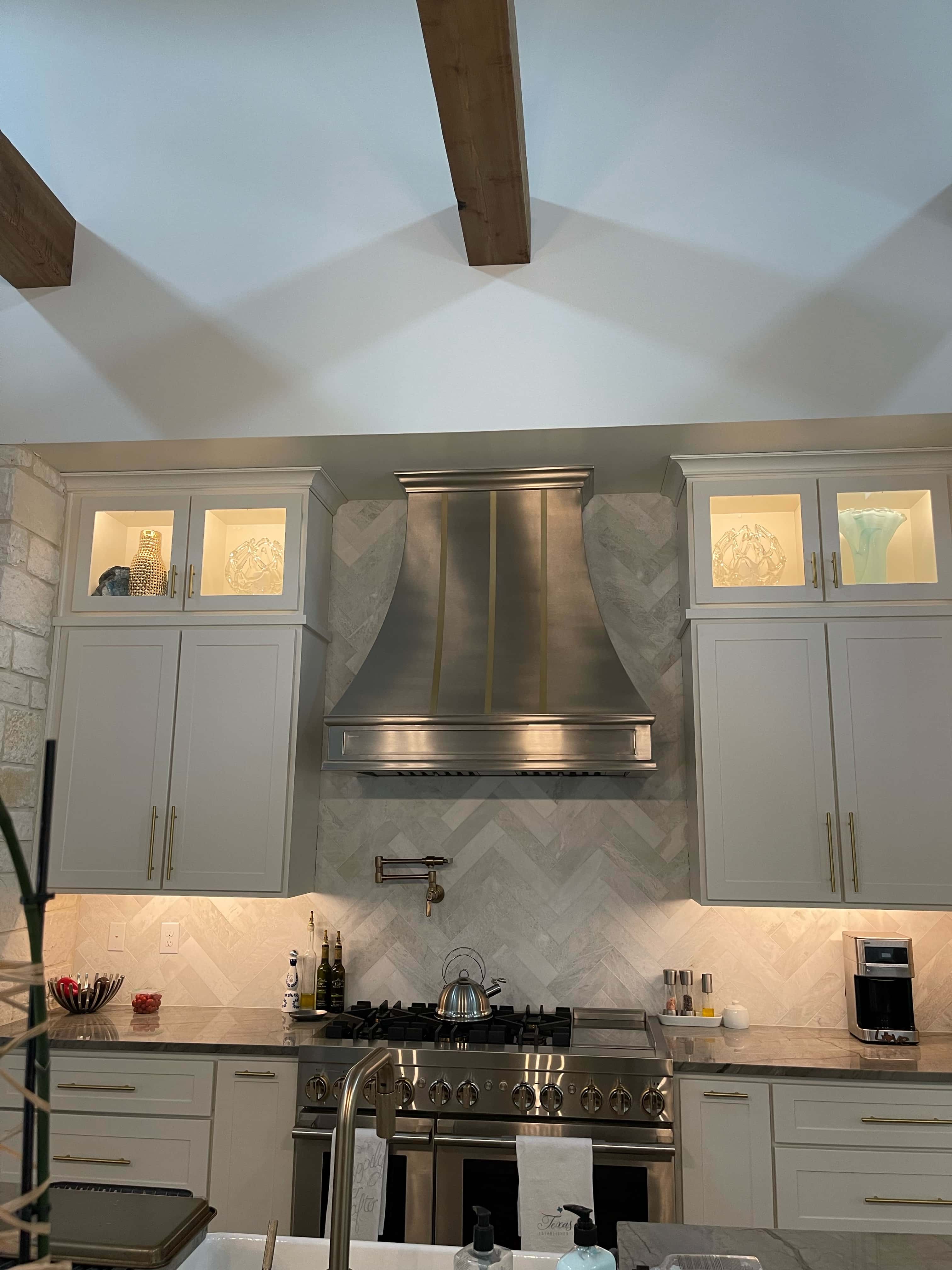 Remarkable range hood captivate classic kitchen planning, enveloped in the pure elegance of white kitchen cabinets