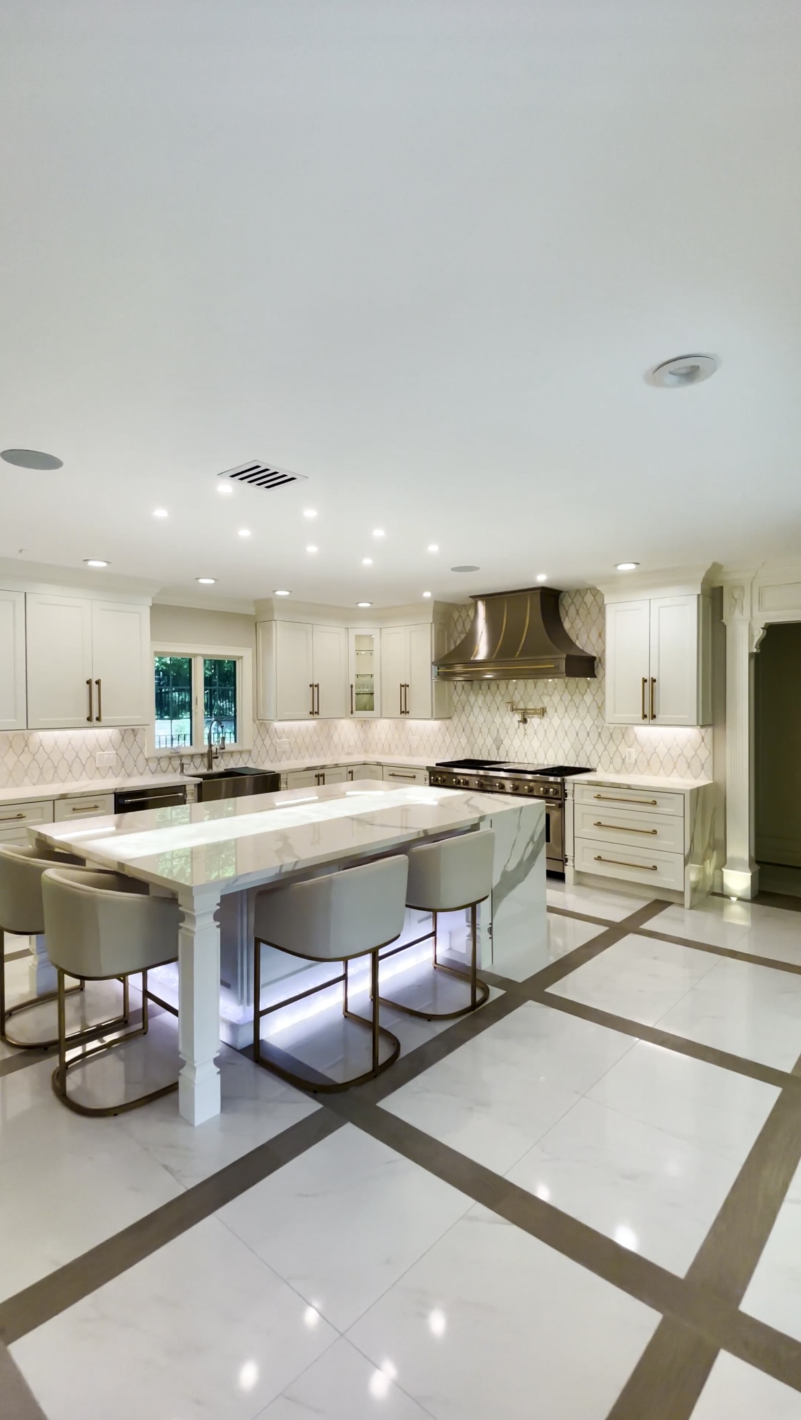 Perfect kitchen design idea, including a french-inspired ,white kitchen cabinets, marble kitchen countertops,a charming brick backsplash, unique kitchen table idea