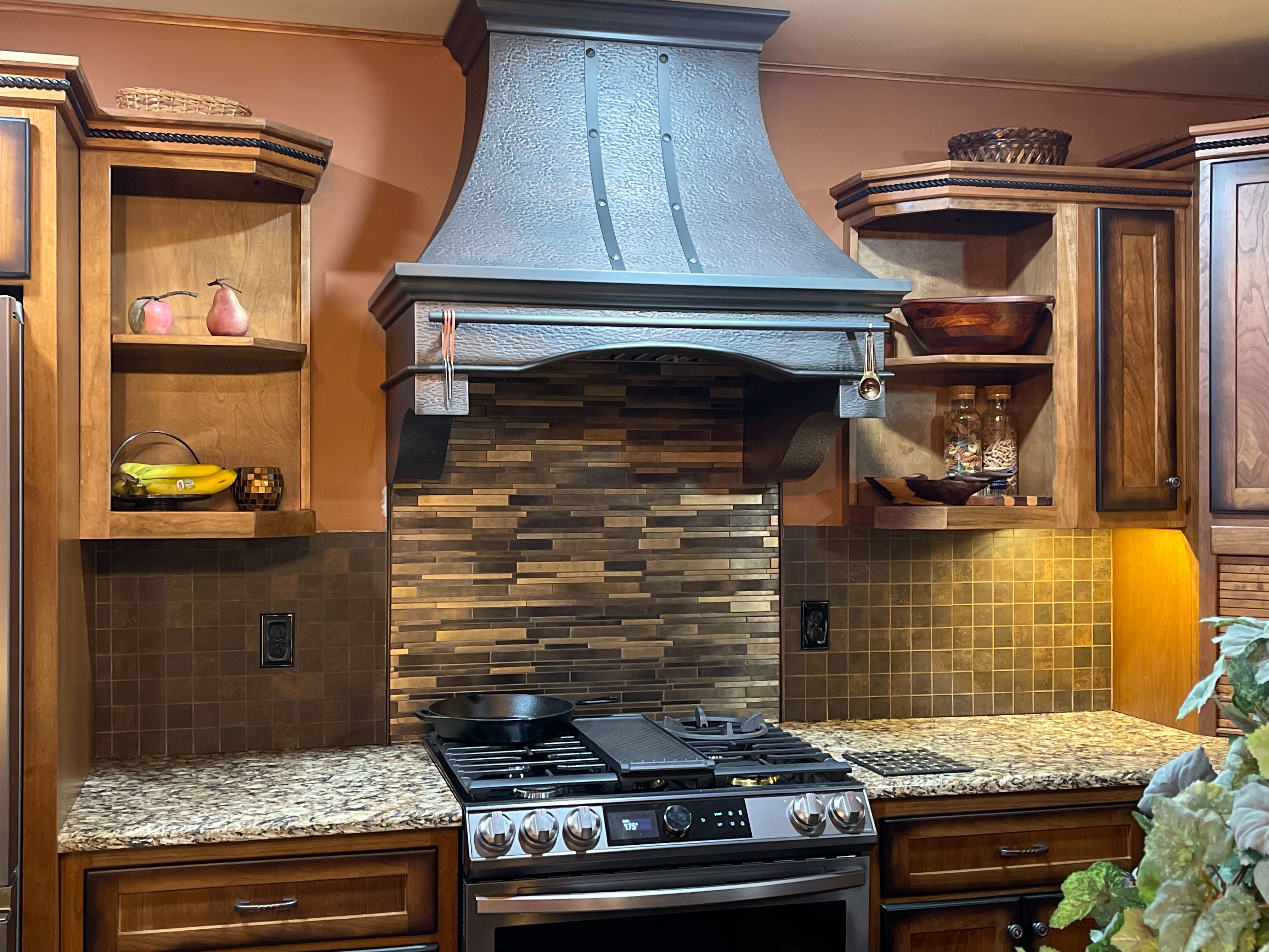 Kitchen design idea featuring,range hood options, timeless craftsman kitchen concepts, rich brown kitchen cabinets,stone kitchen countertops, and brick backsplash